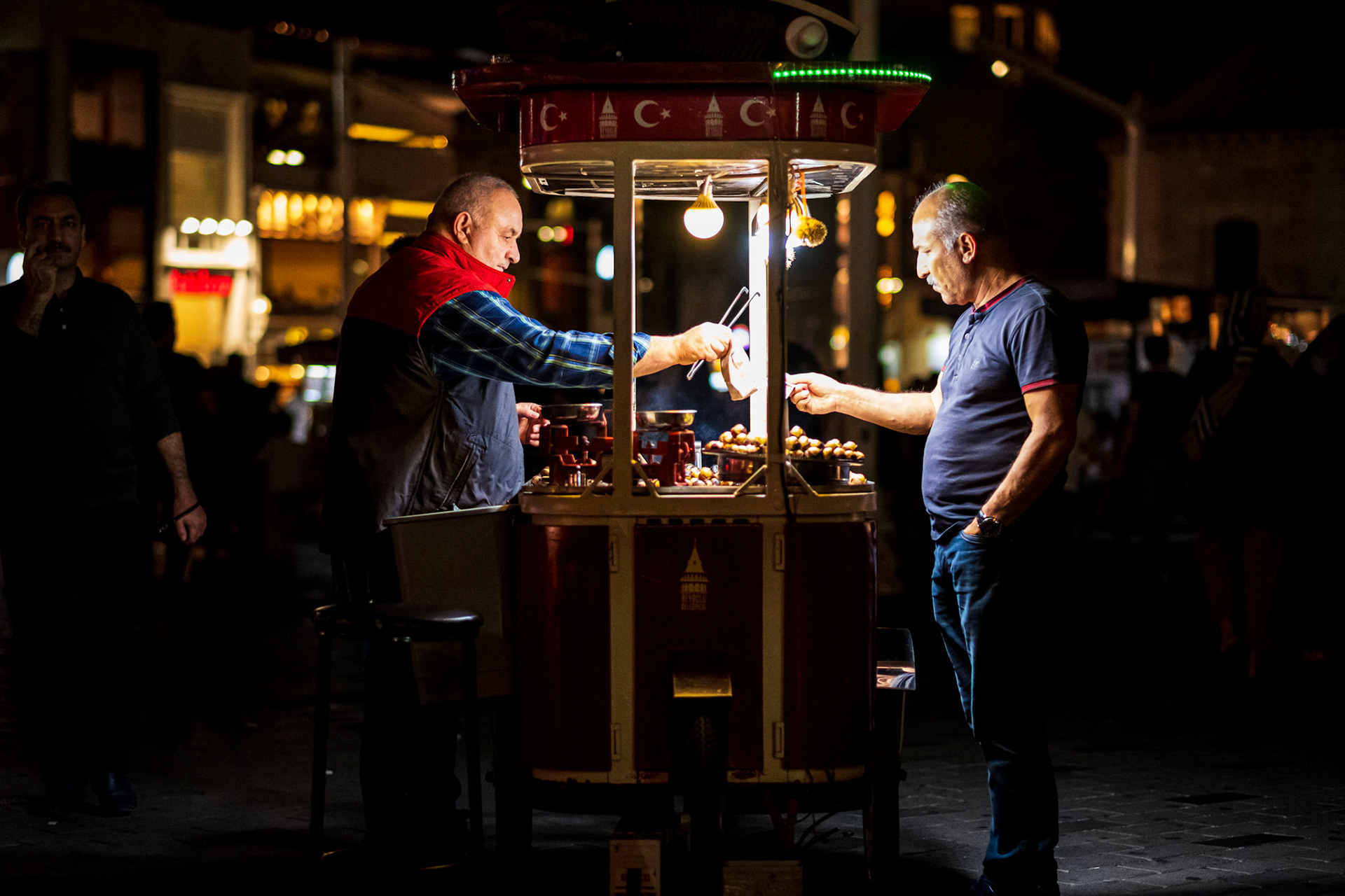 Istanbul, Turkey - 03 September 2019 : Man buying chestnuts in Taksim Square