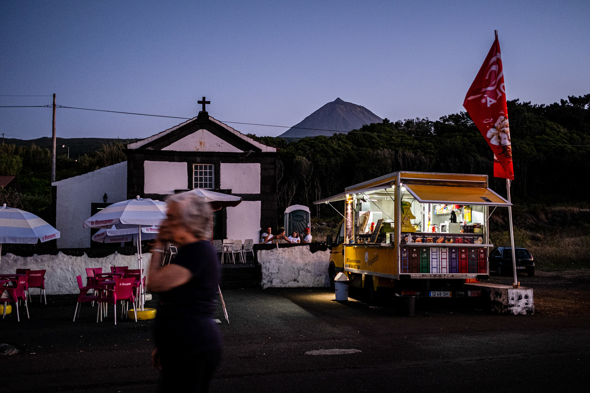 Pico, Portugal - 03 August 2021 : Food truck near a chapel overlooking Pico mountain