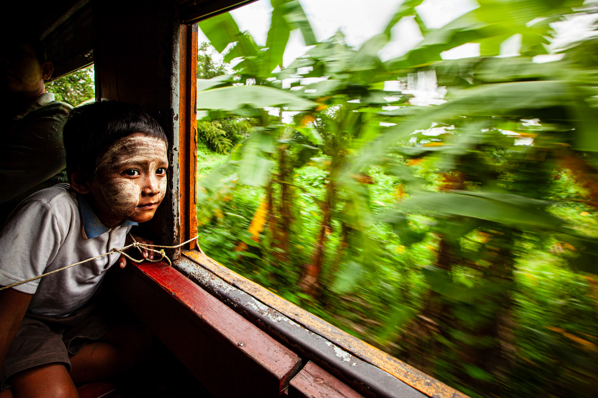 Child enjoying the view from the train. Yangon, Myanmar