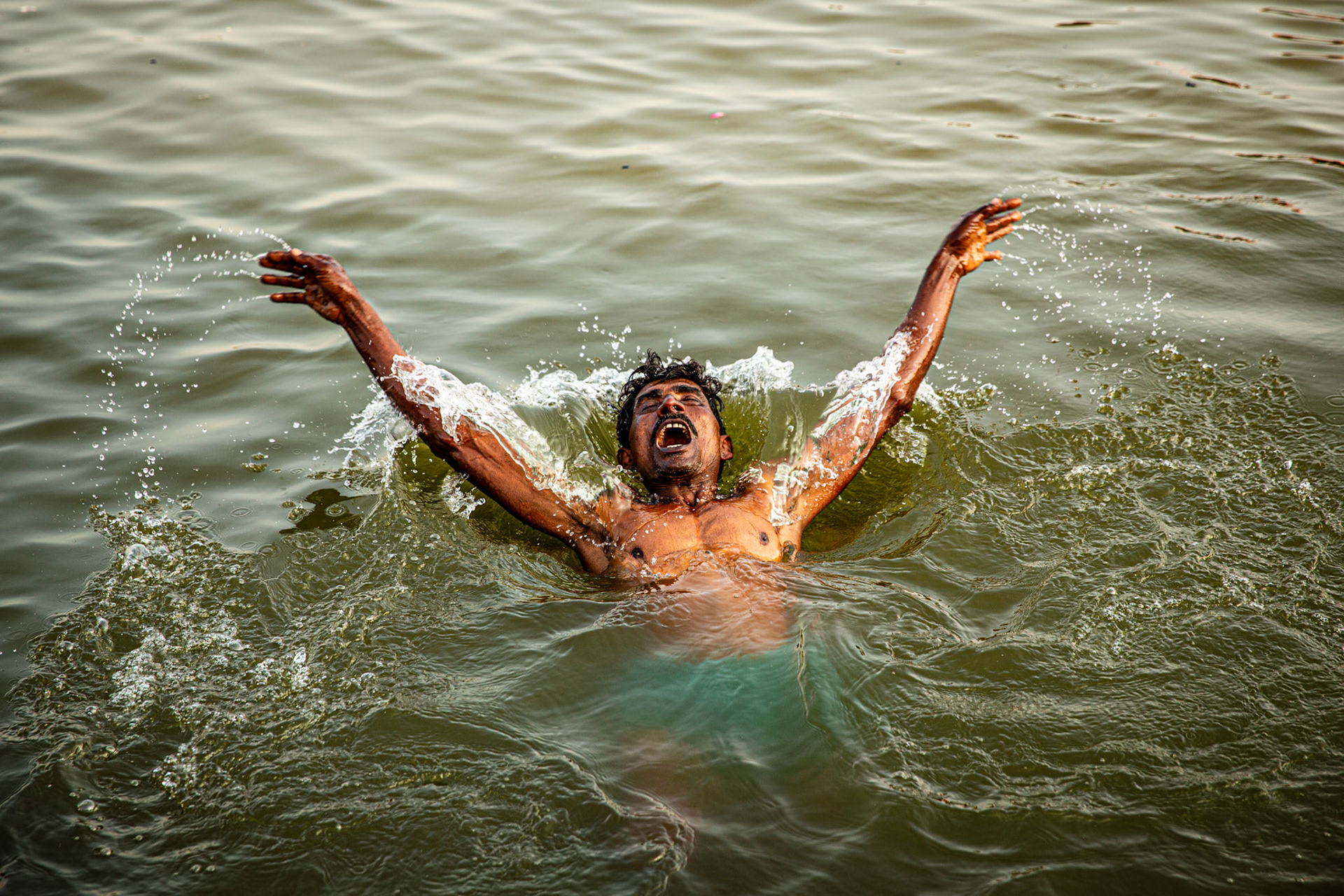 Man bathing in the Ganges. Varanasi, India
