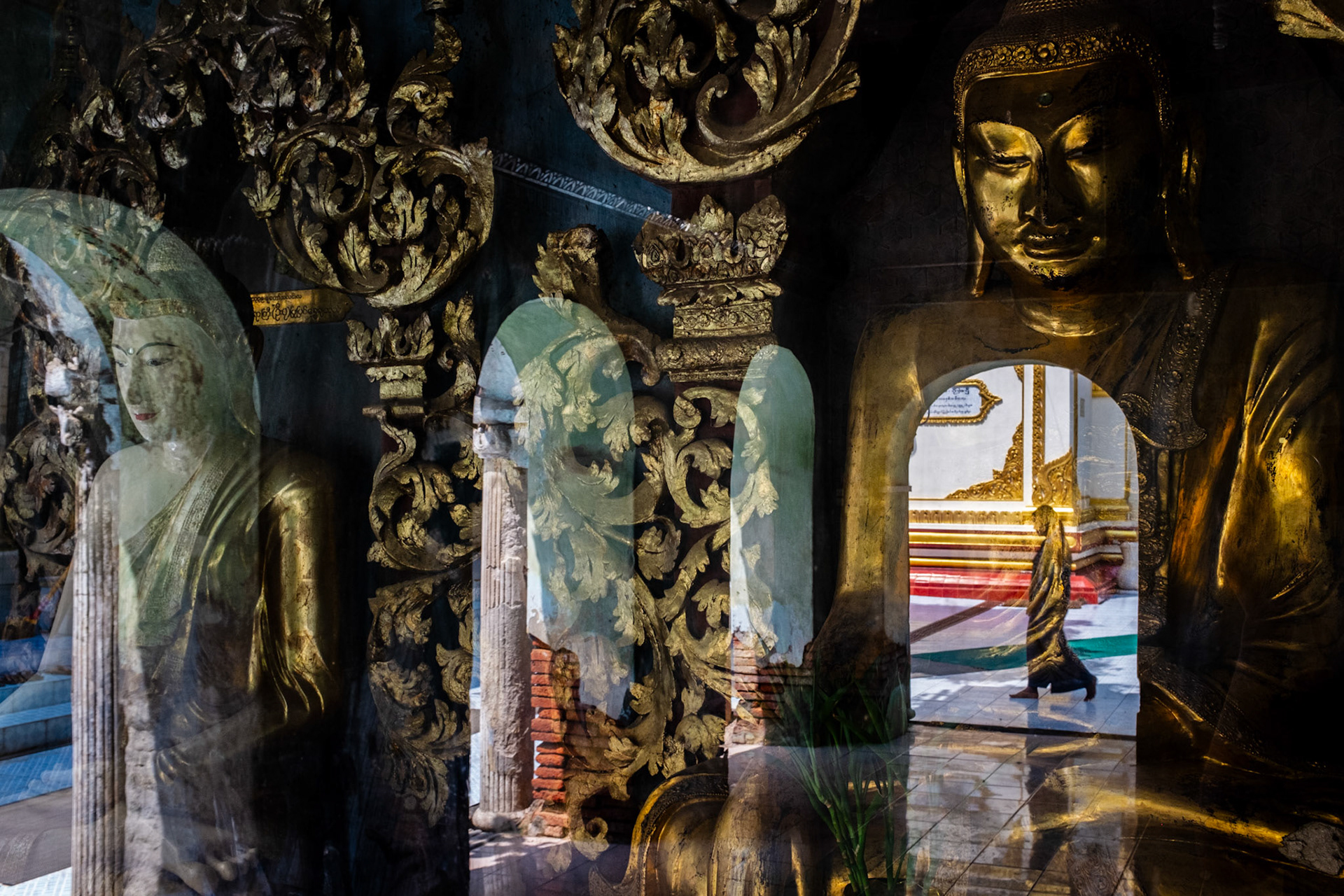 Mandalay, Myanmar - 22 September 2016: Statues of Buddha reflected at Shwekyimyint Pagoda