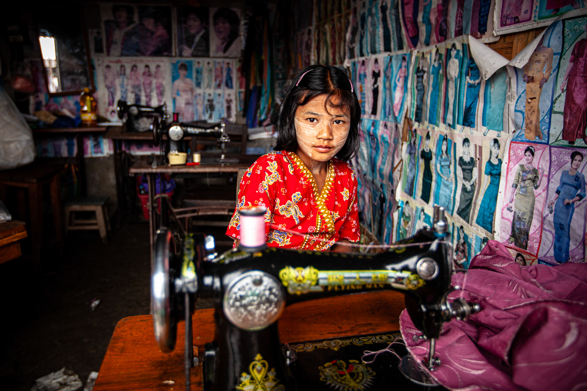 Child seamstress at Nyaung Shwe Market. Myanmar