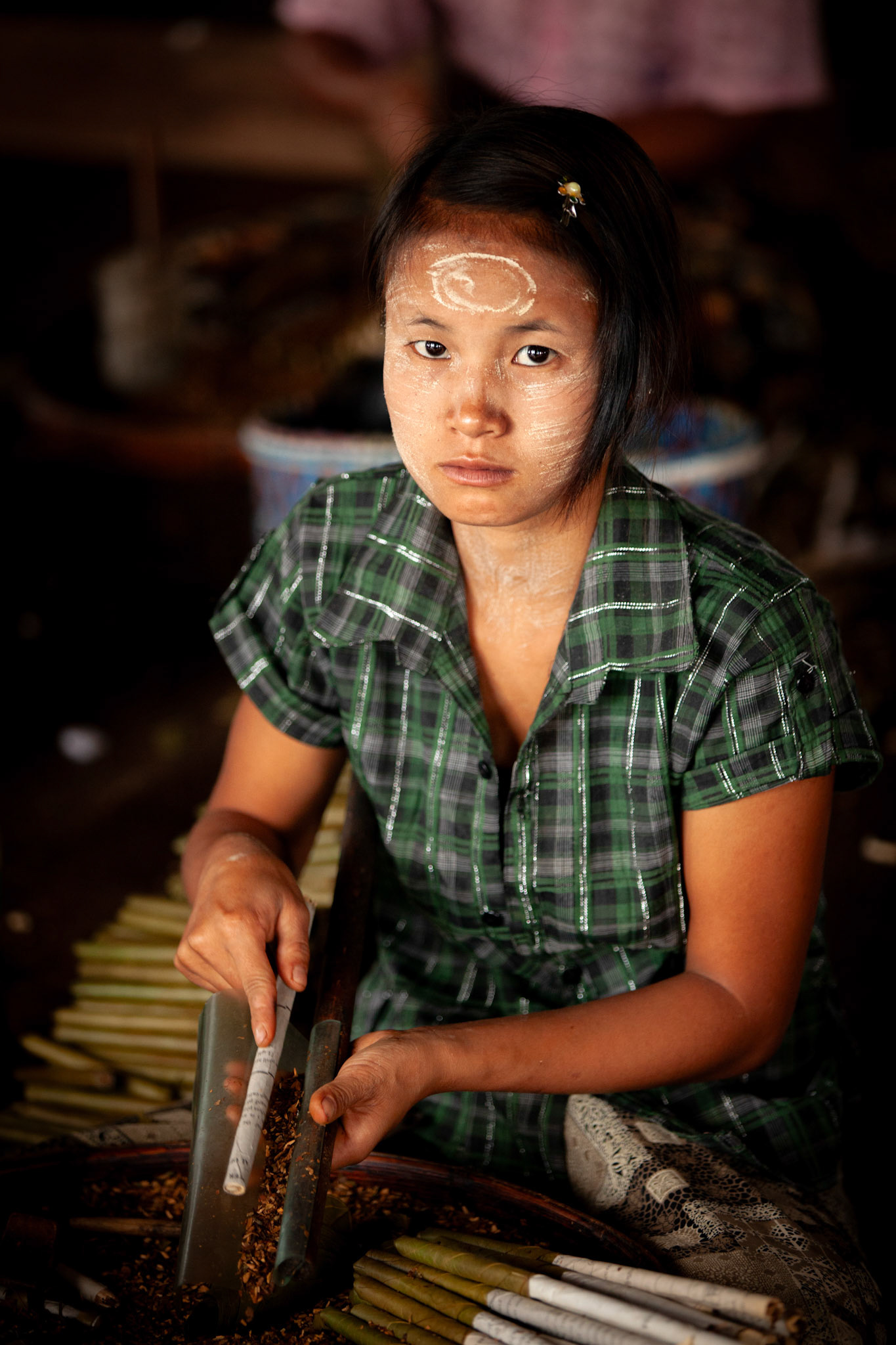 Young woman making cigarettes. Inle Lake, Myanmar