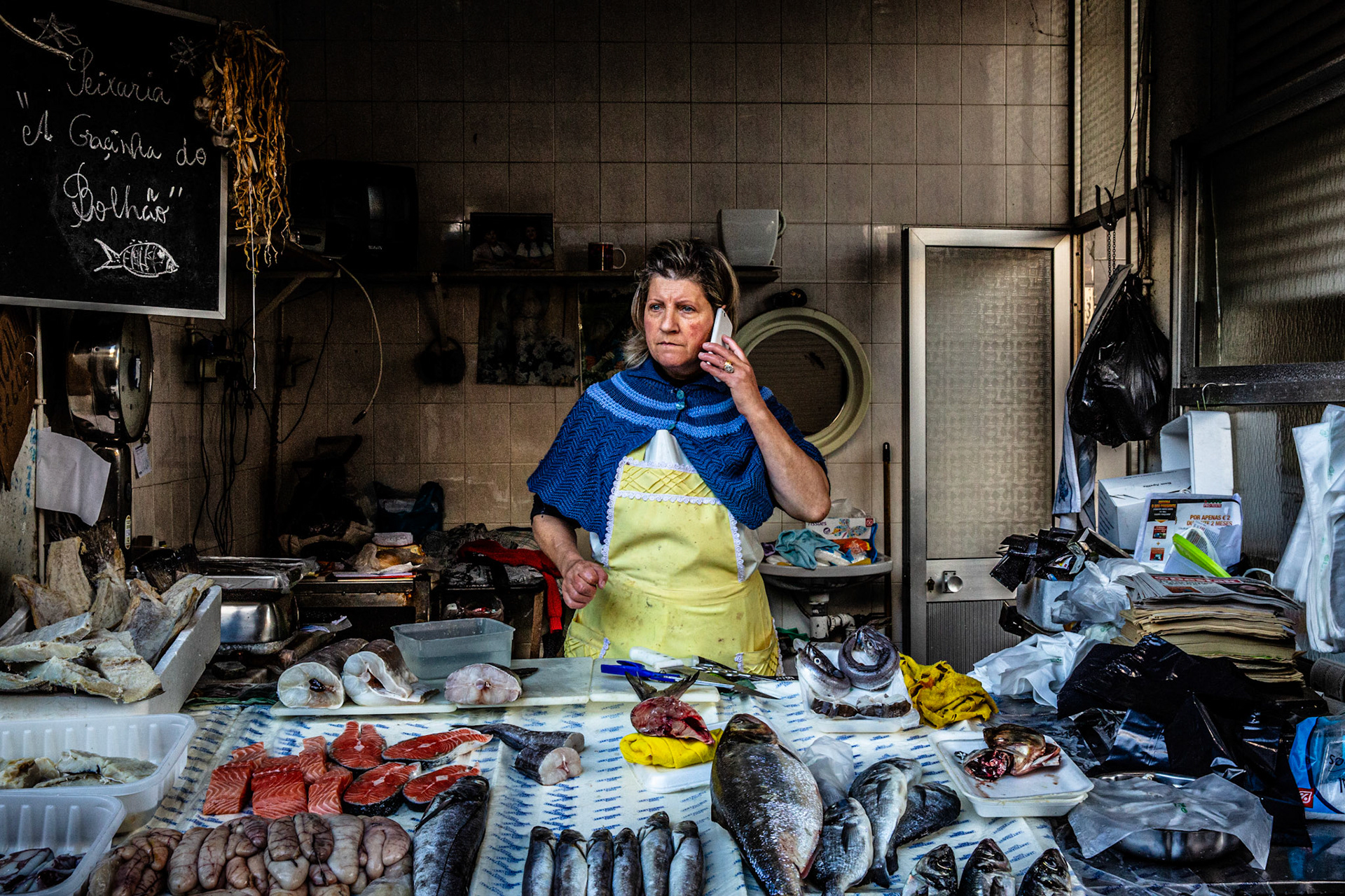 Fishmonger on the phone at Bolhão market. Porto, Portugal