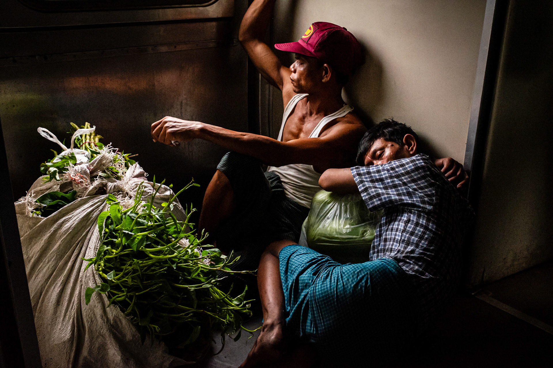 Yangon, Myanmar - 20 September 2016: Vegetable sellers sleeping on the floor of Yangon's circular train