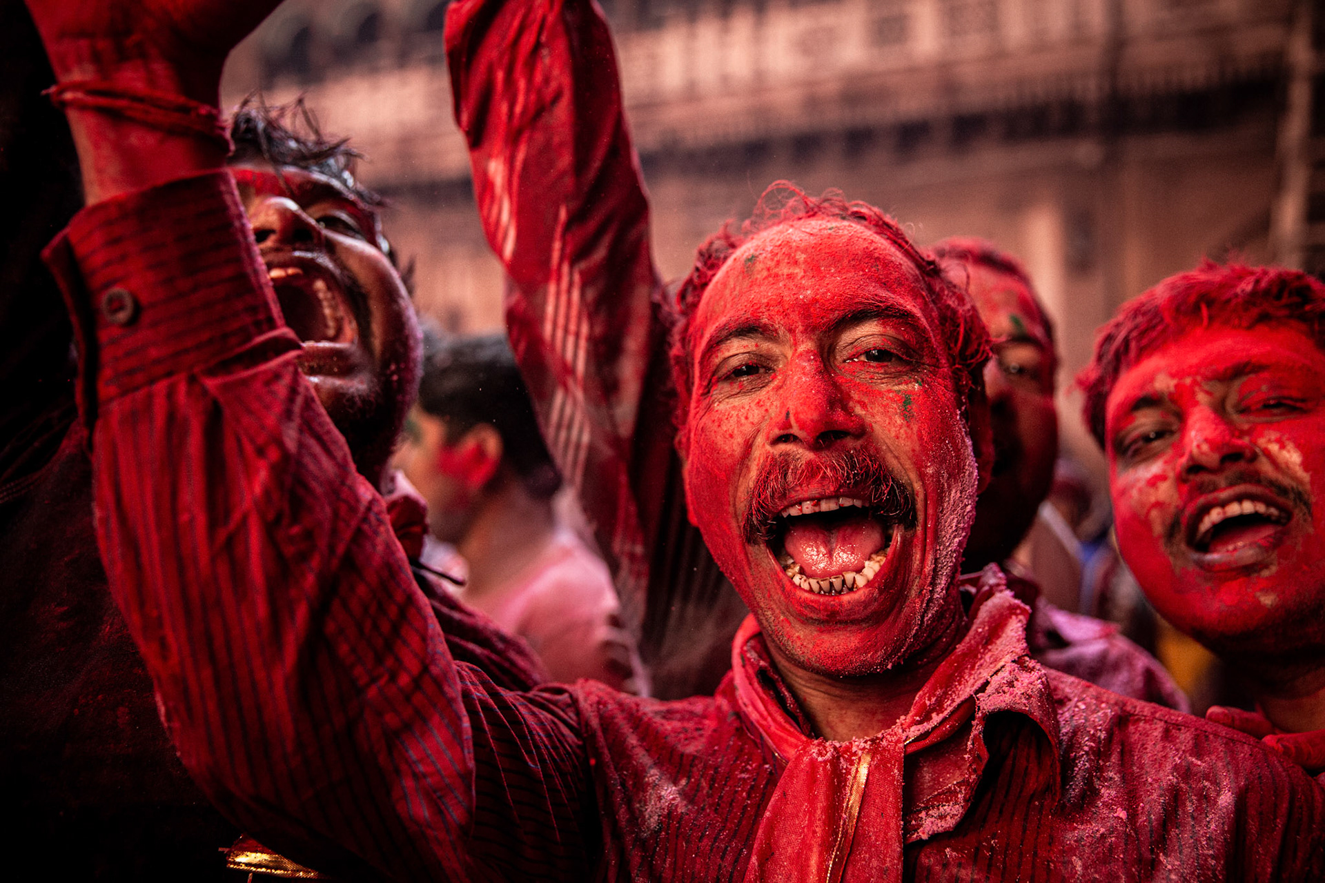 Man covered in red inside Bankey Bihari temple while attending Holi celebrations. Vrindavan, India