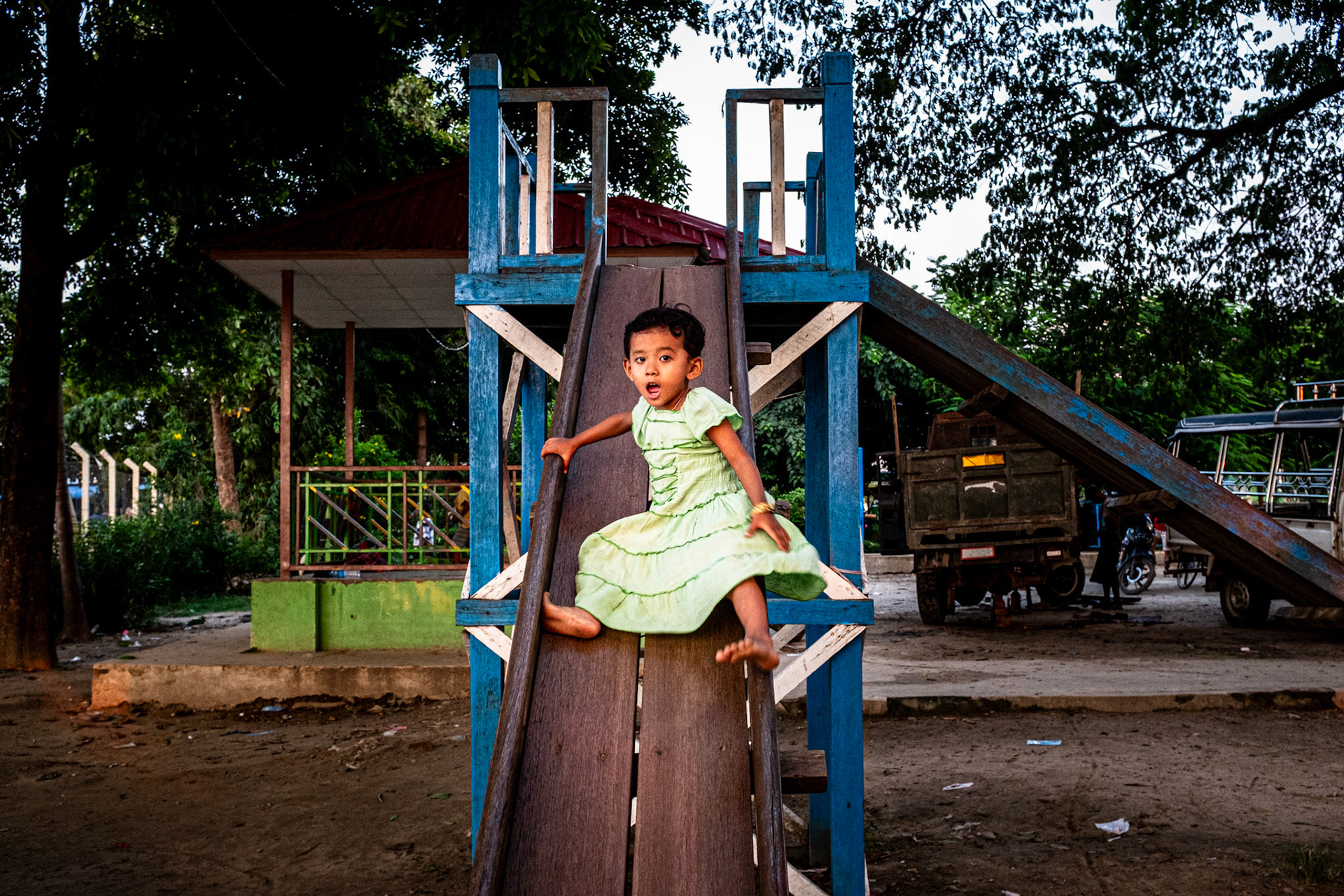 Mandalay, Myanmar - 23 September 2016: Little girl descending on a slide