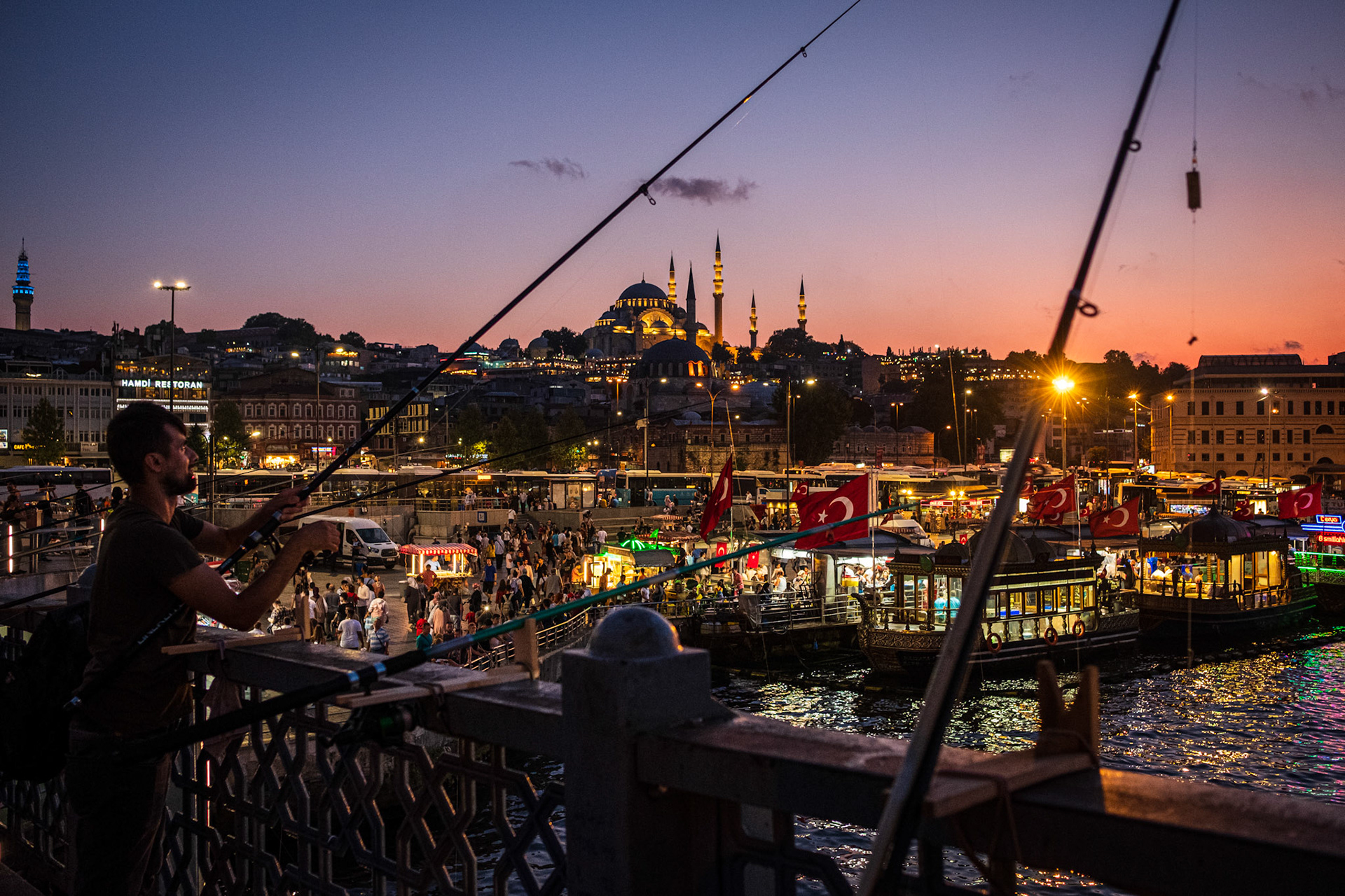Istanbul, Turkey - 26 August 2019 : Fishermen at Galata bridge