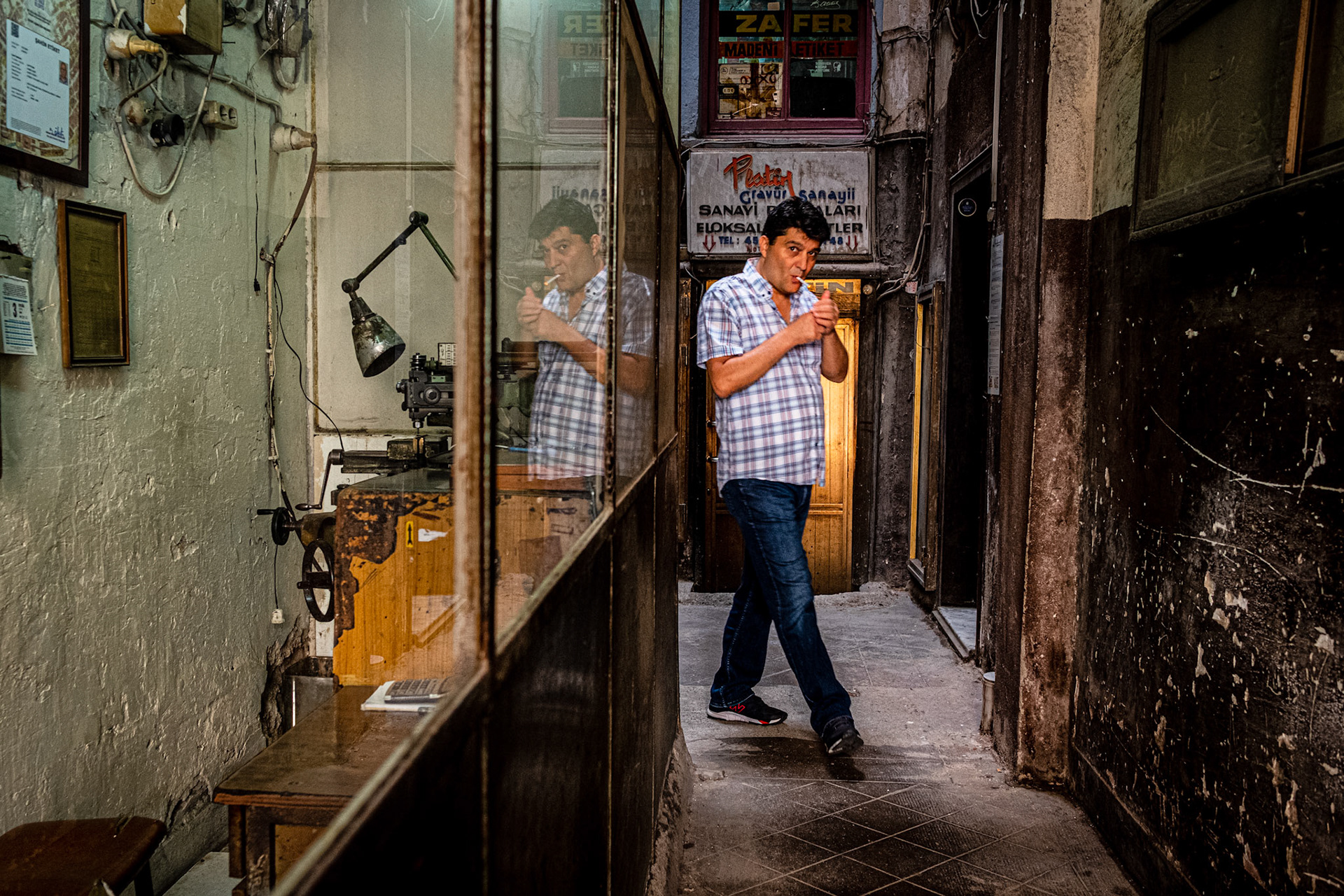 Istanbul, Turkey - 03 September 2019 : Smoking man coming out of a building hall