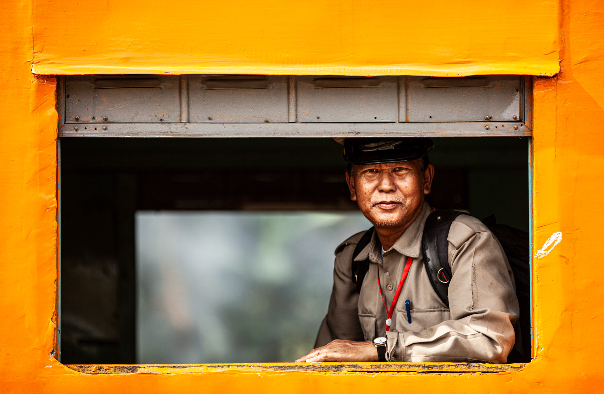 Military man smiling in the train. Yangon, Myanmar