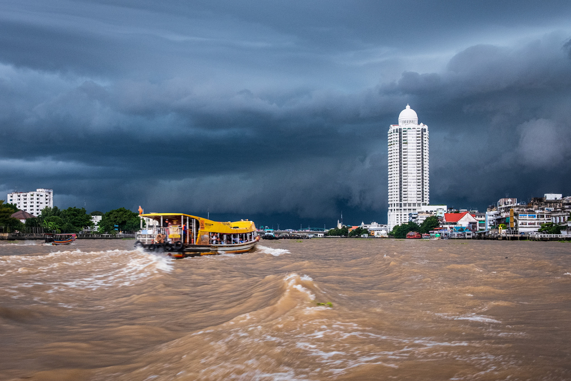 Bangkok, Thailand - 03 September 2018: Boat at Chao Phraya river on a stormy day