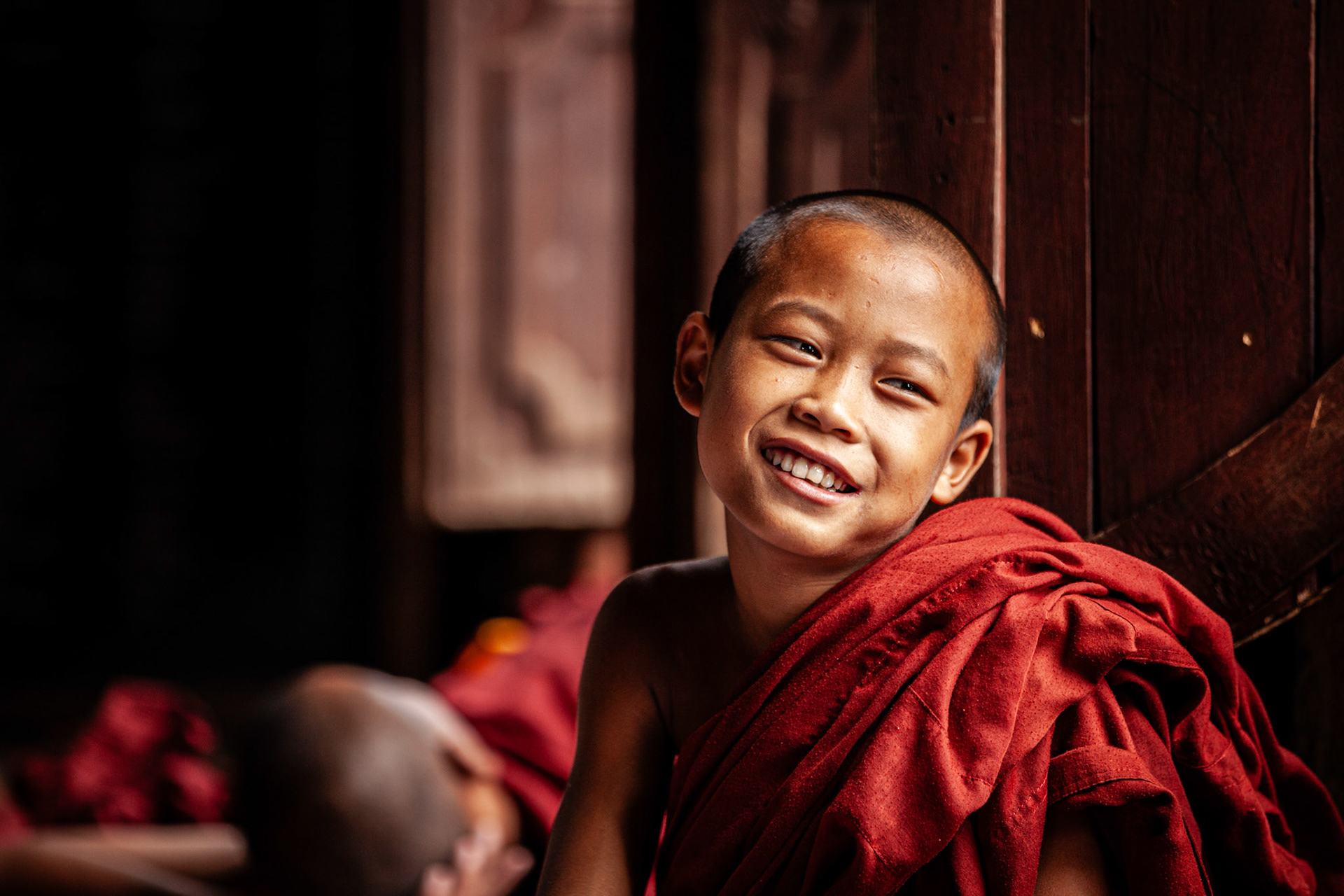 Young monk smiling in Shwe Yaunghwe Kyaung monastery. Nyaung Shwe, Myanmar