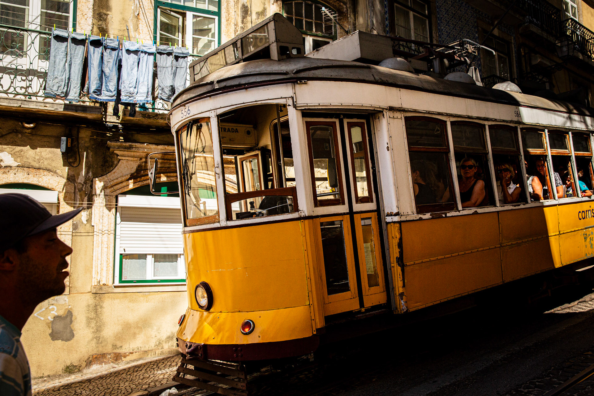 Man passing by a tram in Lisbon. Portugal