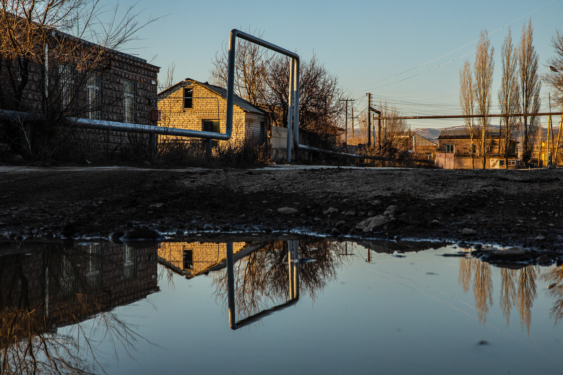 Reflections of gas pipes on a pond. Gyumri, Armenia