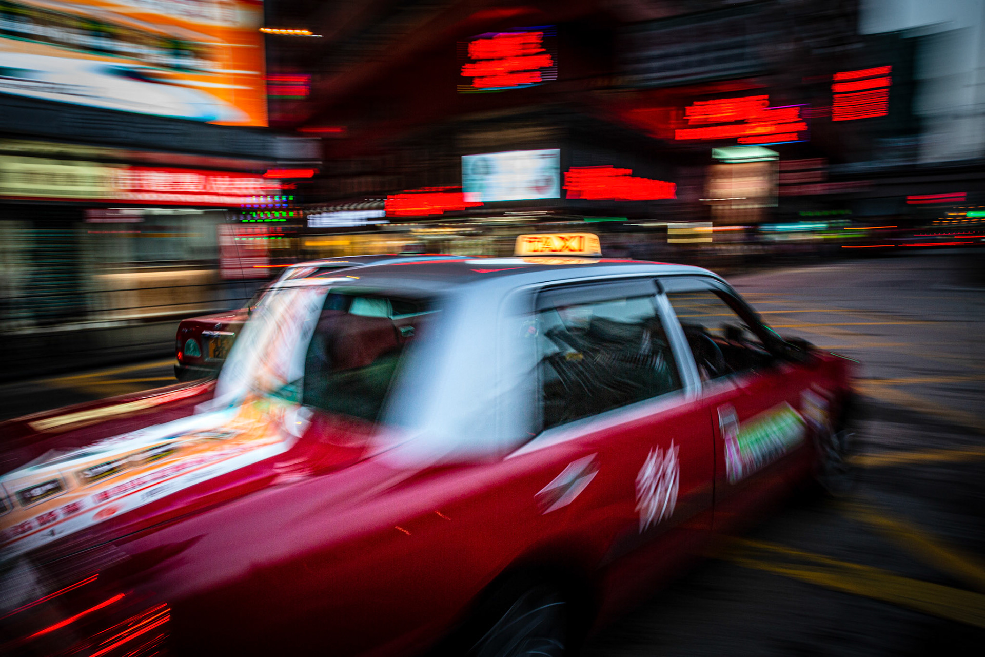 Taxi passing by at Nathan Road. Hong Kong