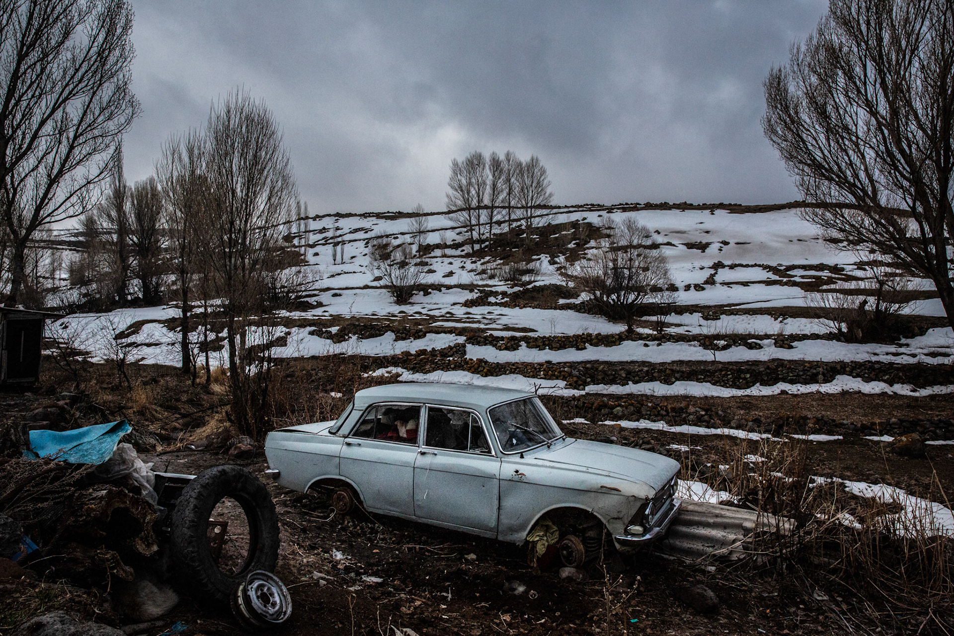 Abandoned car on a snowy landscape at Garnahovit. Armenia