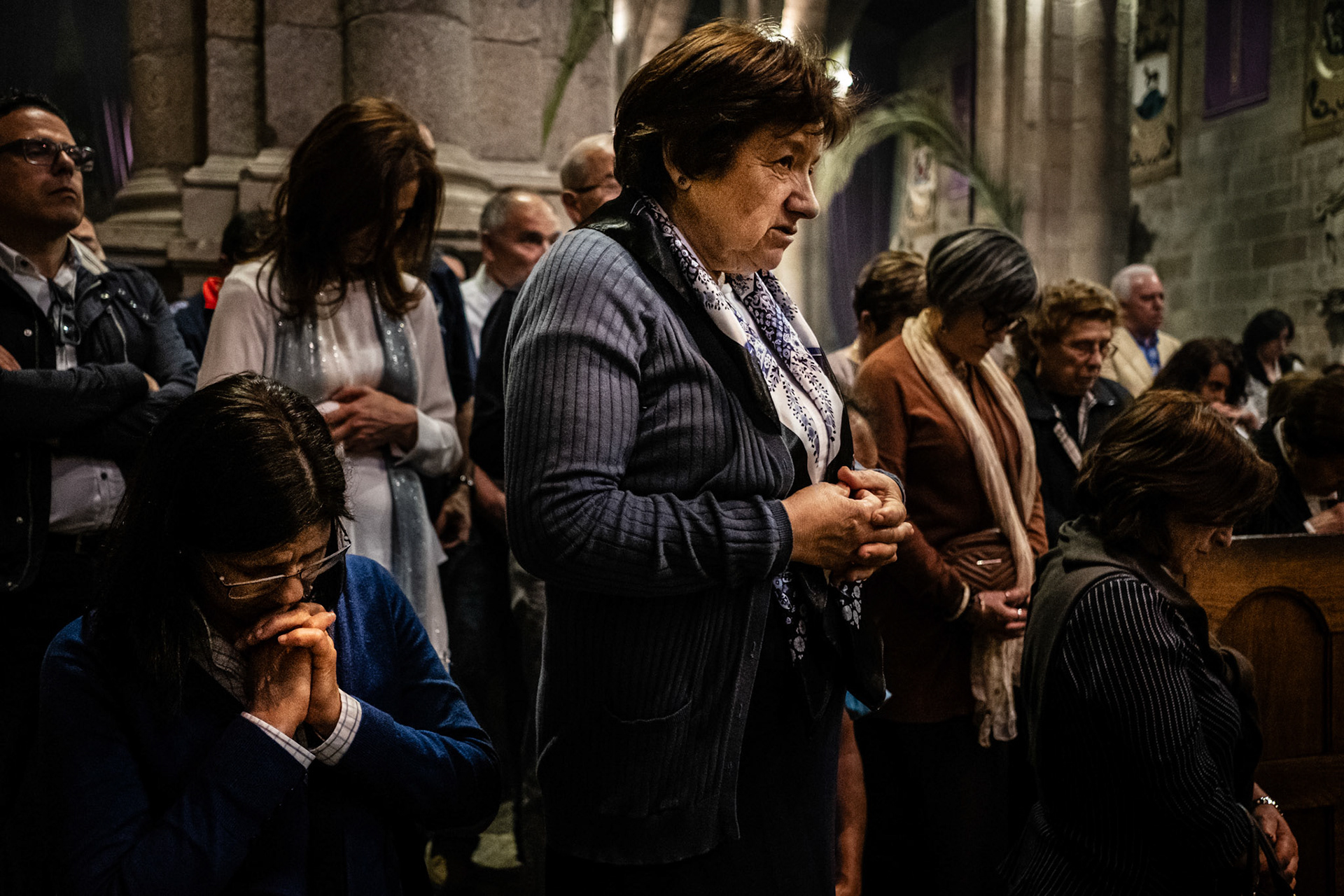 Braga, Portugal - 13 April 2017: People praying during a mass at Braga Cathedral during Holy Week celebrations