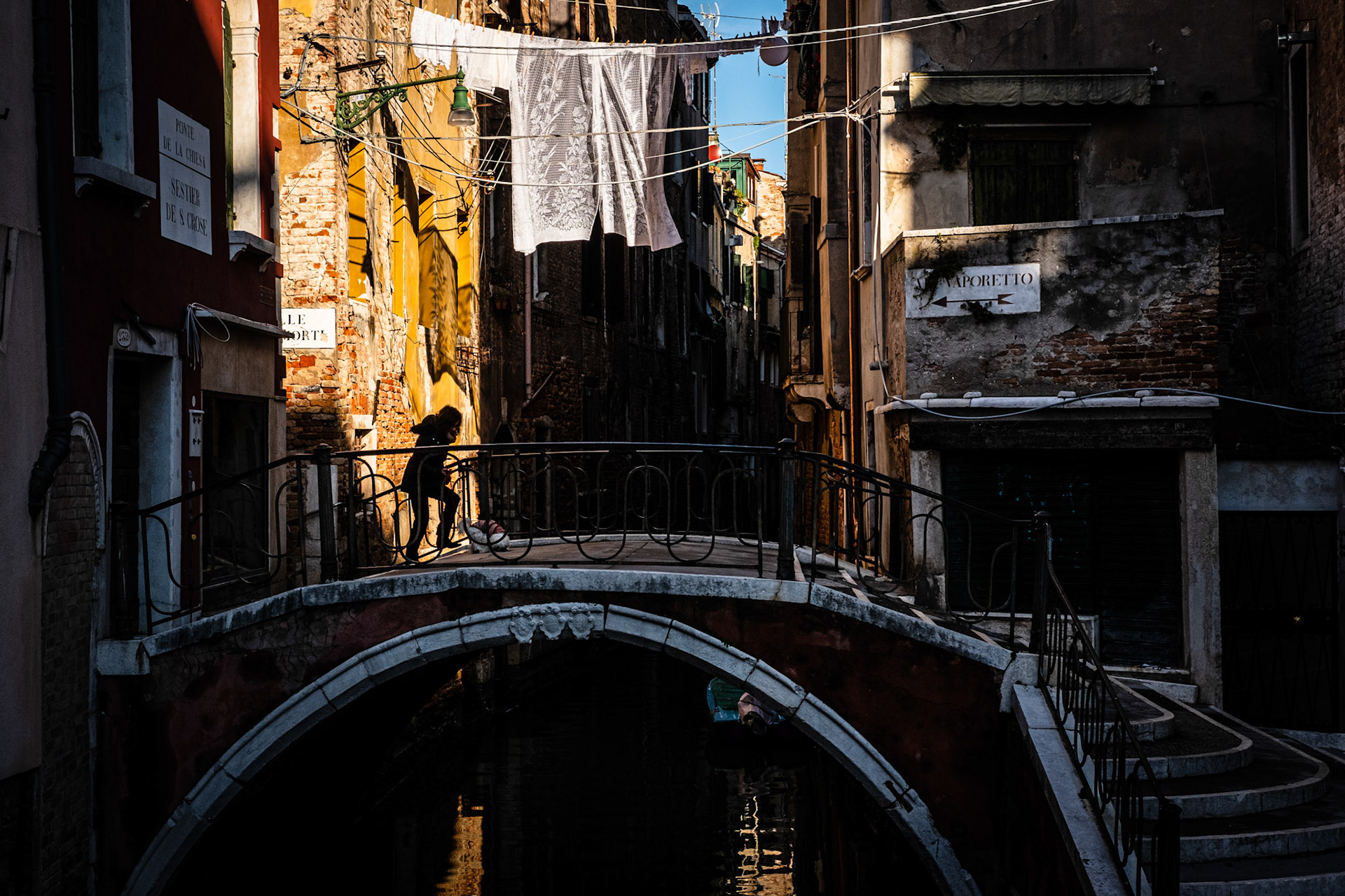 Venice, Portugal - 9 December 2017: Woman crossing a bridge in Venice