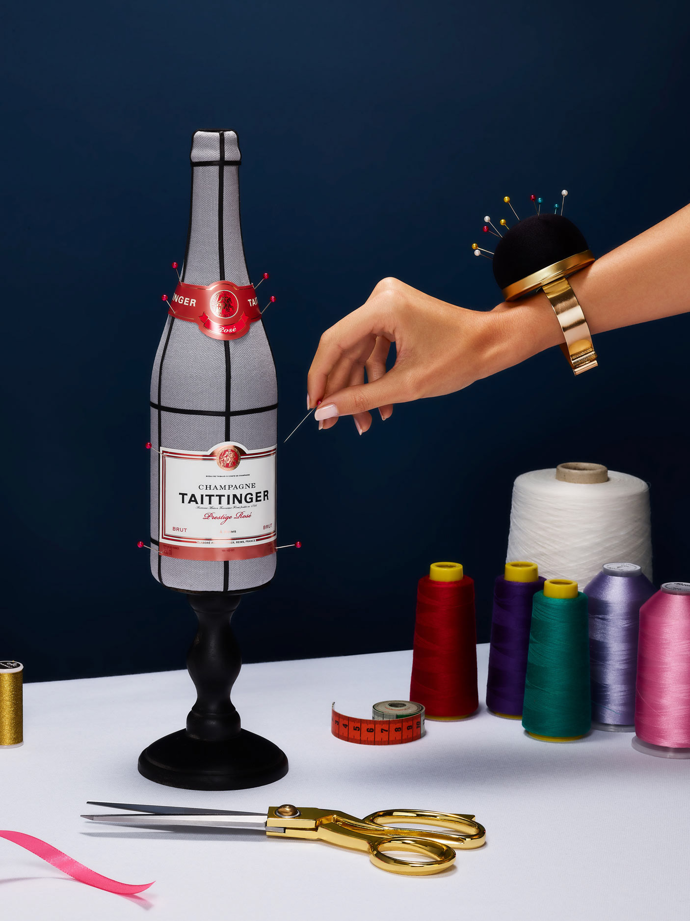 Taittinger, PALAST - still life photography, hand model, a bottleof champagne with a label being adjusted in a couture atelier in Paris ,  Paris France