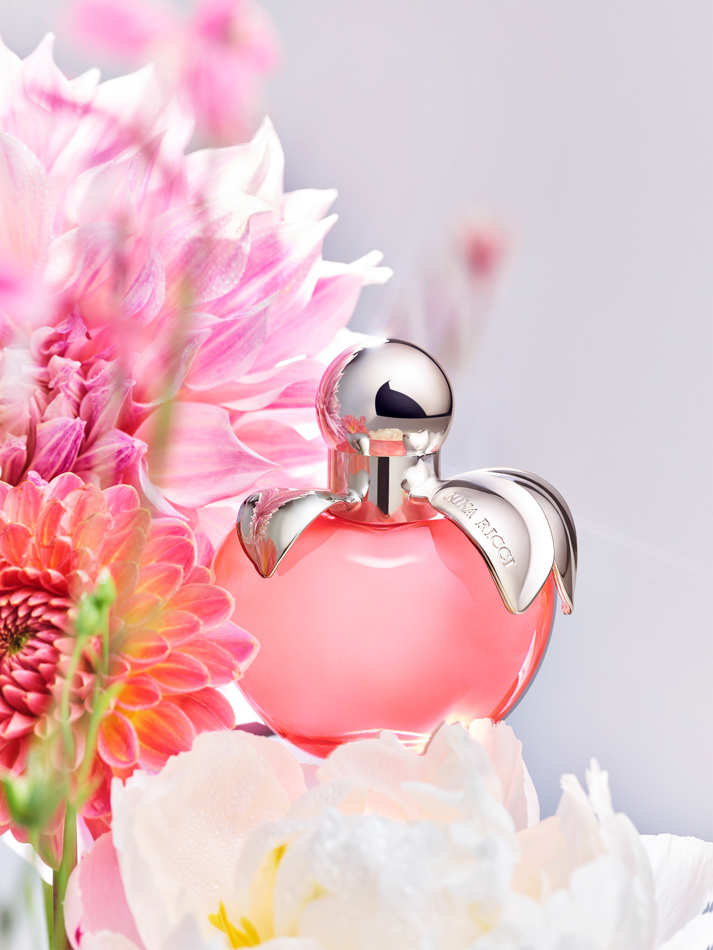 Nina Ricci Parfums : Nina Nature, photographie de nature morte, parfum, photographie d'un flacon Nina Ricci entouré de plantes et fleurs - PALAST PHOTOGRAPHIE, Paris France