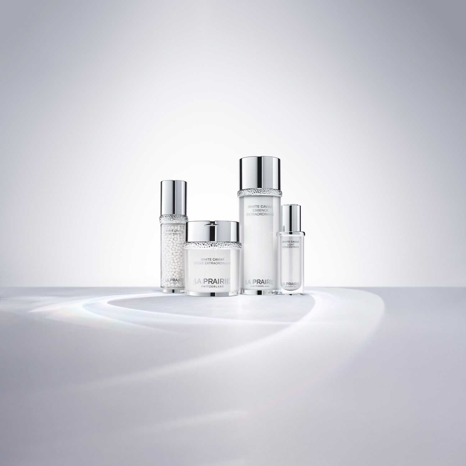 Still life photo La Prairie Cosmetics, white caviar product range on a white background, with caustics