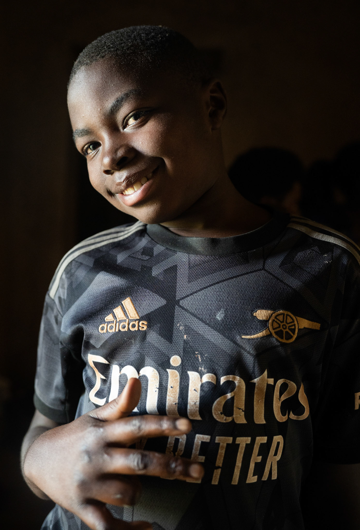 Irene wears an Arsenal jersey that features the globally-known Visit Rwanda logo on the sleeve.  Football is hugely popular for Rwandan youth, and Visit Rwanda’s sponsorship deals have inspired many to cheer for teams including Arsenal and Paris Saint-Germain.   One of Rwanda’s most promising young players, 18-year-old Barthazar Ndayshiminaye, plays for European giants FC Bayern Munich in Germany. (Photo/Evan Frilingos 2026)