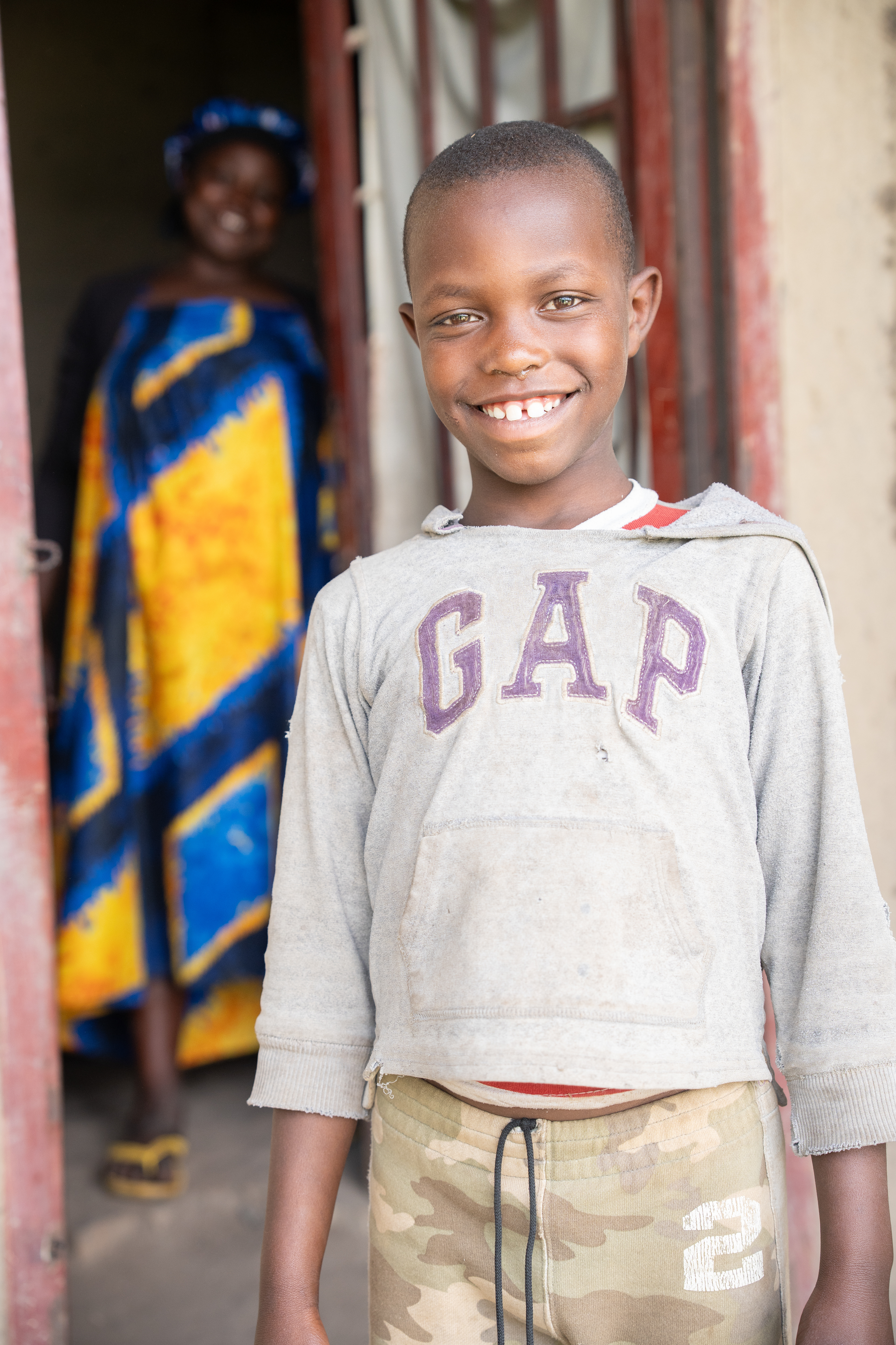 Remi asked for a photo when his mom, Alice, appeared in the doorway behind him at their under-construction home in rural Kamara village in the Muhanga district. Alice said being around her children is her favorite thing about them, but that she hopes they will go and “finish school and live a good life,” which includes having money to pay for clothes, food and rent, she said.   Education is key to improving generational wealth in Rwanda, where equal access to high-quality education is a core target of the government’s Vision 2050. (Photo/Evan Frilingos 2026)