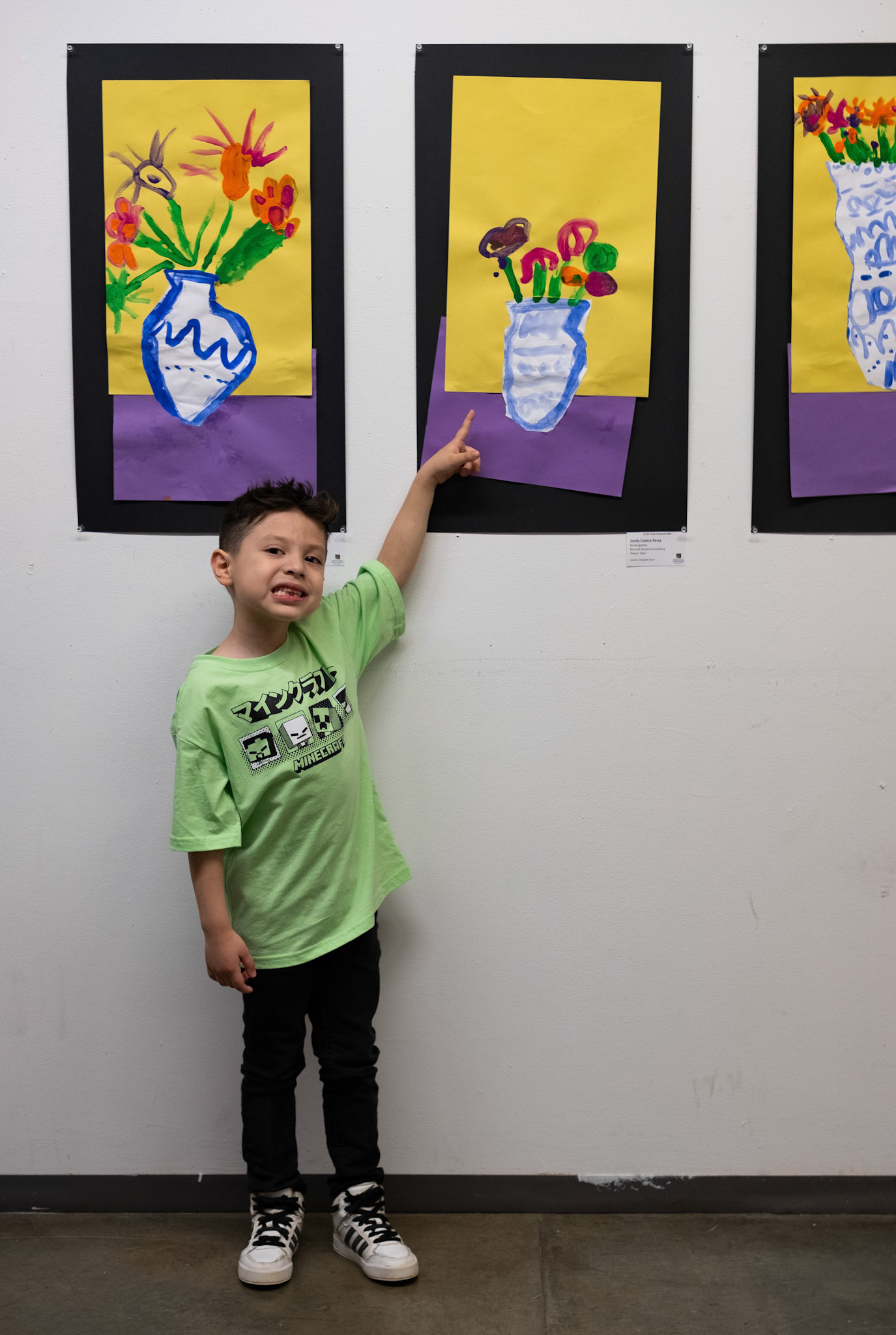Jordy Castro Pena points to his piece "Flower Vase" at the CCSD Youth Art Exhibition at the Lamar Dodd School of Art in Athens, Georgia on Sunday, March 24, 2024. (Photo/Evan Frilingos; @frilingos.photos)