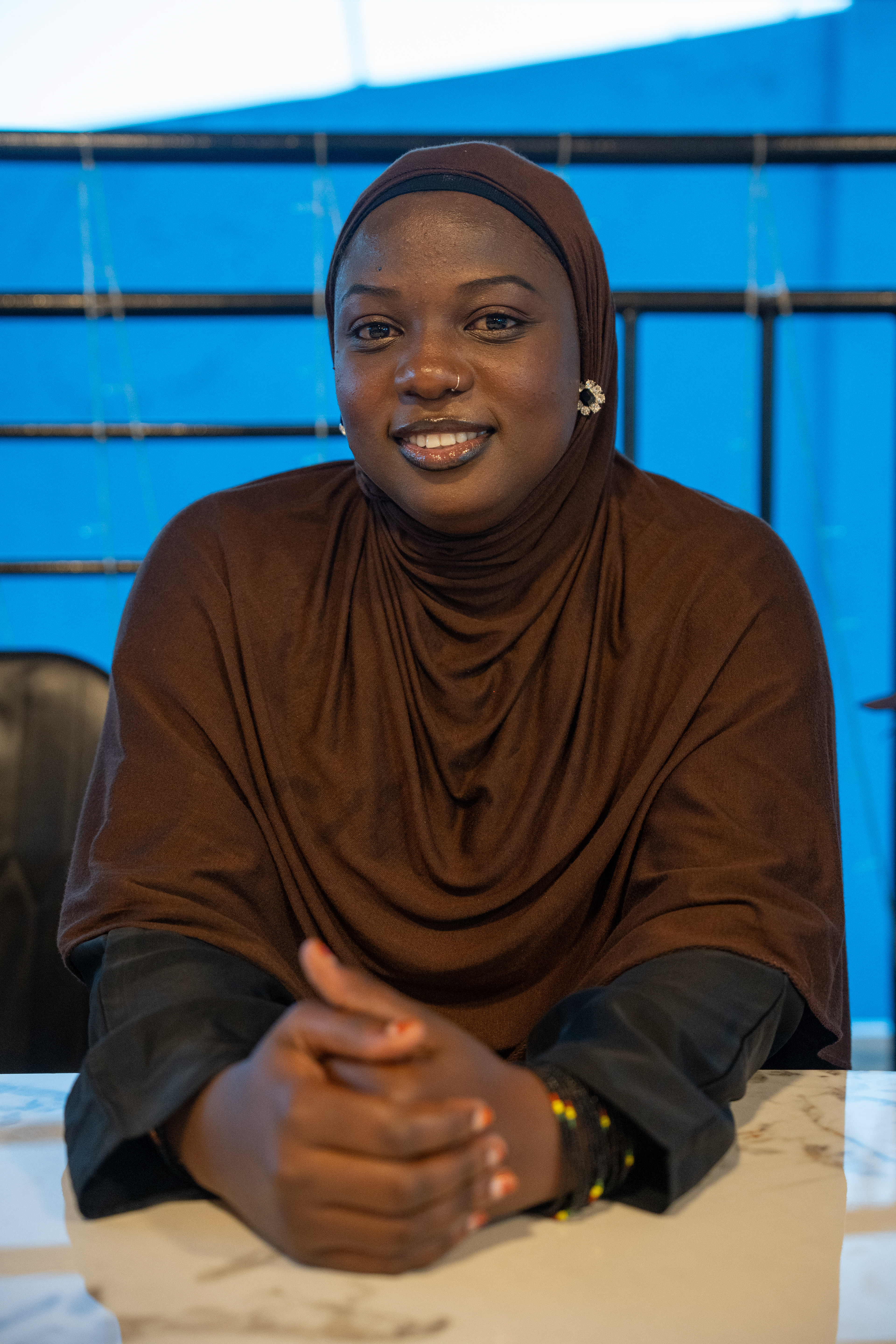 Shadia Umotoniwase, a tour guide at the Nyamirambo Women’s Center, poses for a photo on Tuesday, May 19, 2026 in Kigali, Rwanda.   NWC is a women’s empowerment community hub that provides education and job resources to women who can’t afford them. It was founded in 2007 to address gender-based violence and discrimination.   Umotoniwase’s job helps bring money to NWC through community tourism. Working for this organization reflects her love for her grandmother, who took care of her as child, Umotoniwase said.   “Still now, I can say she’s the one who is my best friend,” she said. (Evan Frilingos/ Evan Frilingos 2026)