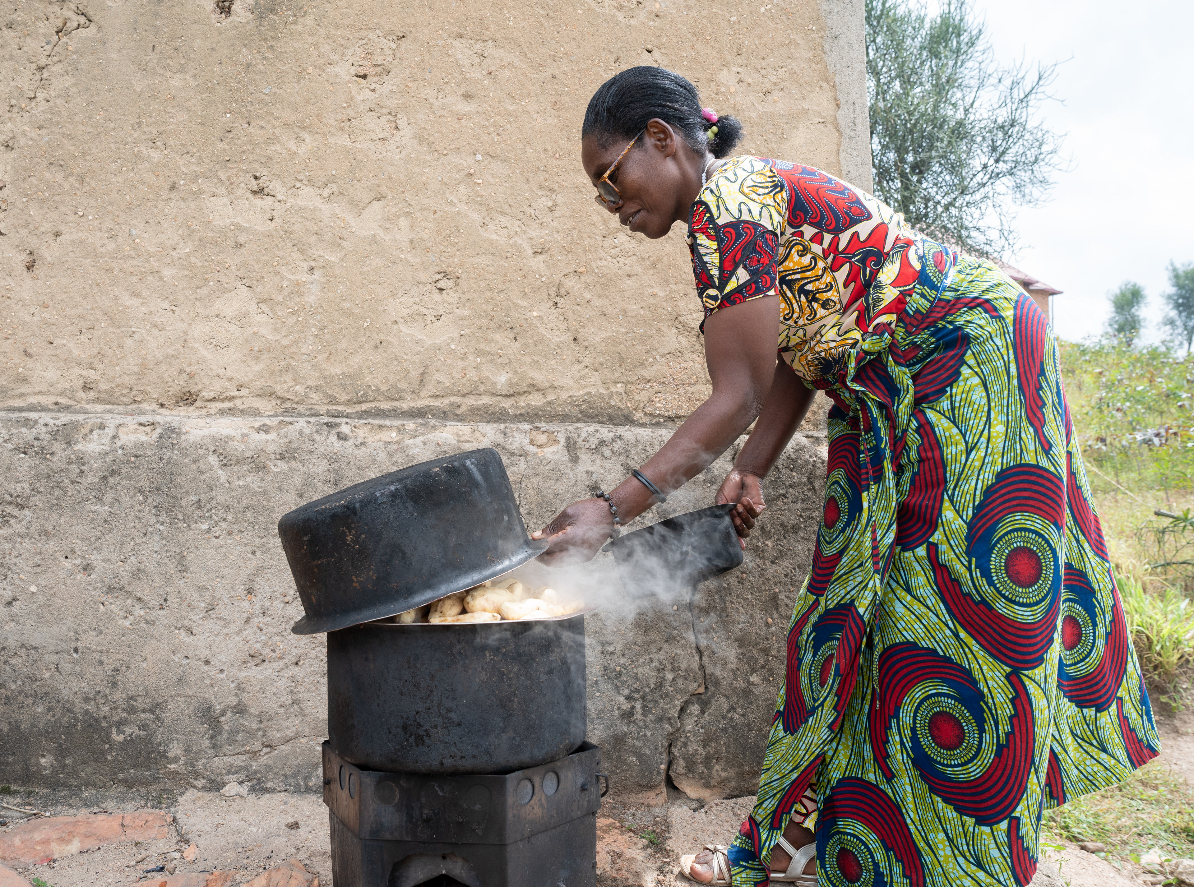 Flortine boils sweet potatoes while preparing a dish called ingereke at a rural home on Sunday, May 24, 2026 in Karama, Rwanda.   Traditional Rwandan meals consist of mostly vegetarian items like sweet potato, beans, avocado, plantains and corn. Meat is more common in urban areas and fish is common near lakes.   (Photo/Evan Frilingos)