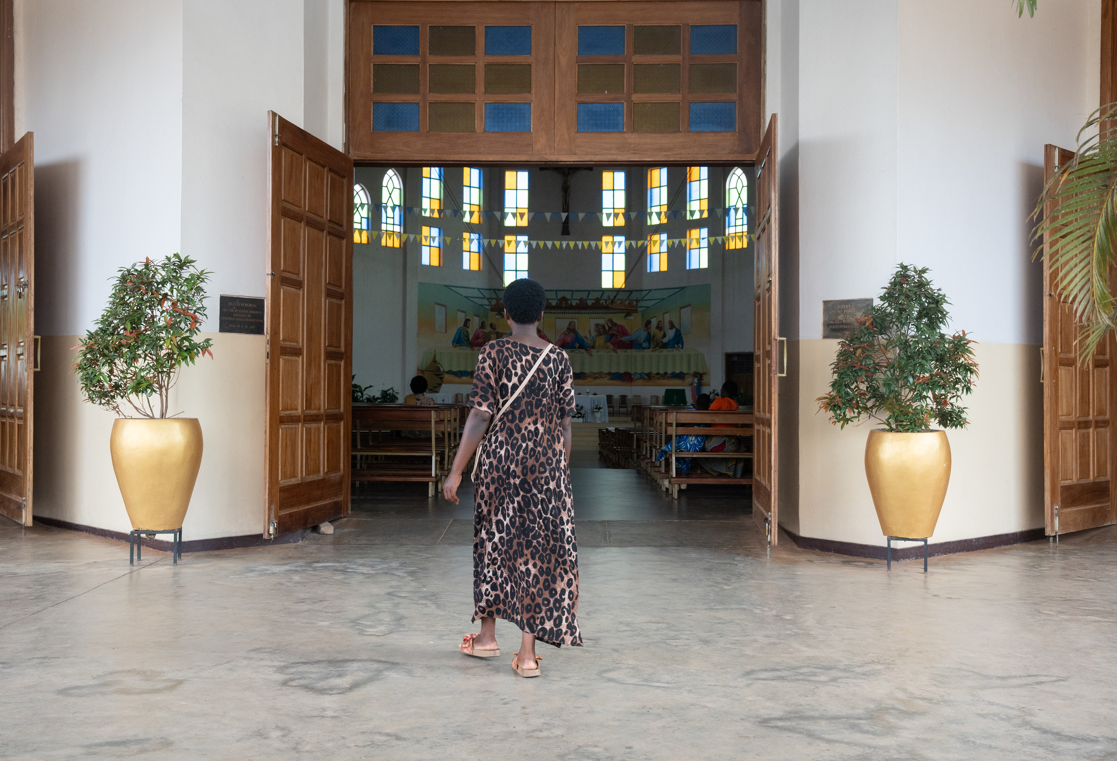 A woman enters the Catholic Paroisse Regina Pacis Remera church on Friday, May 29, 2026 in Kigali, Rwanda.   Catholicism maintains the highest proportion of Christian Rwandans, but Protestant numbers have been increasing and are projected to surpass the declining Catholic numbers. The Protestant increase mirrors a broader one occurring across the Global South, but some Rwandans said the decreasing Catholic numbers could be a result of the role some Catholic Churches played in collaborating with perpetrators during the genocide.  (Photo/Evan Frilingos 2026)