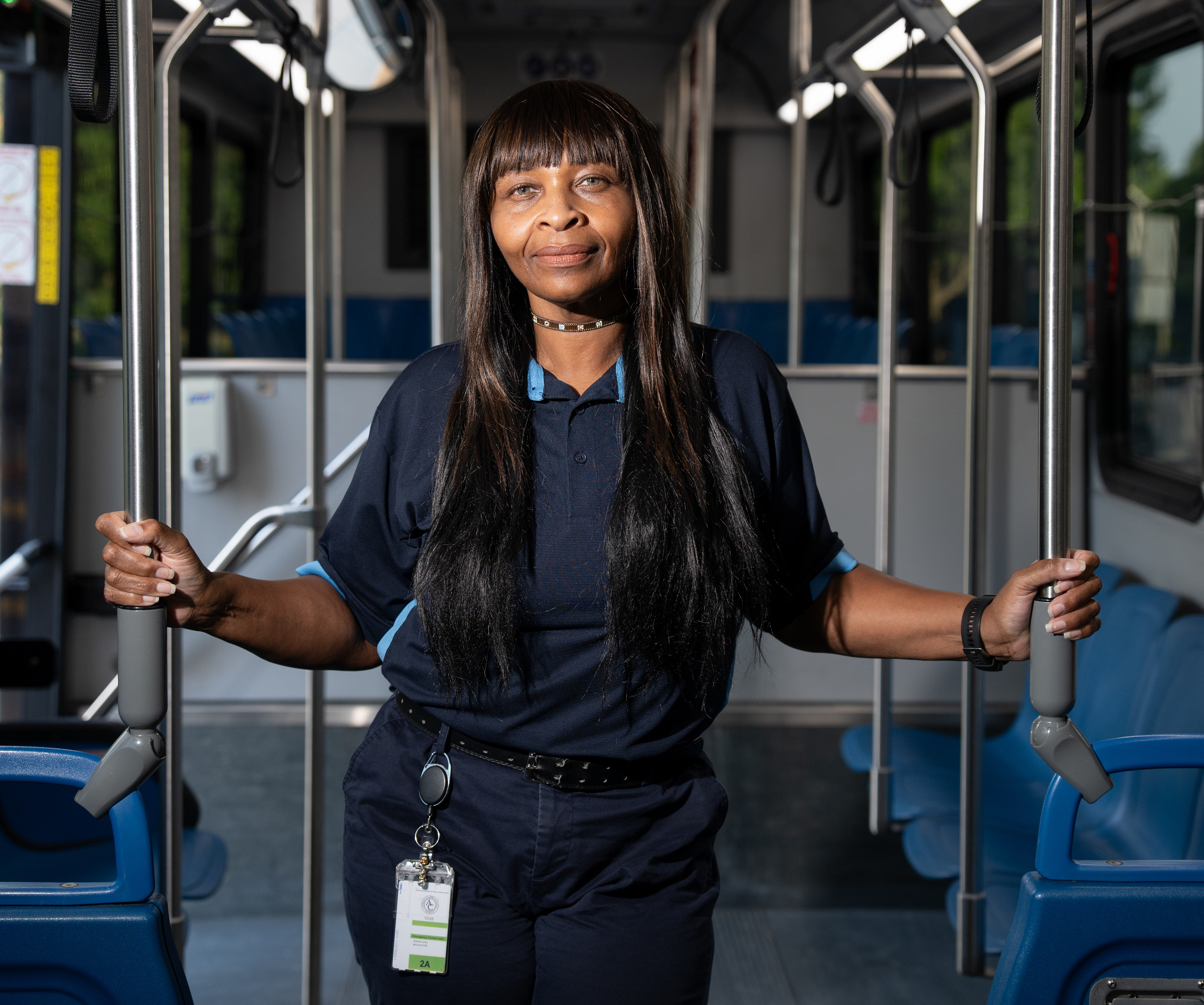 Katherine Lewis, 52, an Athens-Clarke County Transit bus driver from Augusta, Georgia, poses for a photo inside her bus at the ACC Multi-Modal Transportation Center on Sunday, September 06, 2026 in Athens, Georgia. ACC bus drivers get Labor Day off, but while Lewis said she understood the importance of rest, she’d rather be out driving her bus. “I don’t want to be boxed in,” she said. “I want to outside, I want the fresh air, I want to be doing something … I think if life afforded me and I was rich, I could do this.” Lewis, whose nickname is “Sunshine,” said in 25 years of driving buses, the COVID-19 pandemic made her realize how important her job was in making people feel seen and checked on. “If I had happiness dust, I would sprinkle it everywhere, you know,” she said. “I want to see and be a part of this world that I want to see and come back to me, which is all the light, the shine, the caring parts. Just to be there for somebody that really needs me and that loving, caring person. You may spend 10 minutes with me on this bus, but let me make that 10 minutes your best 10 minutes.”