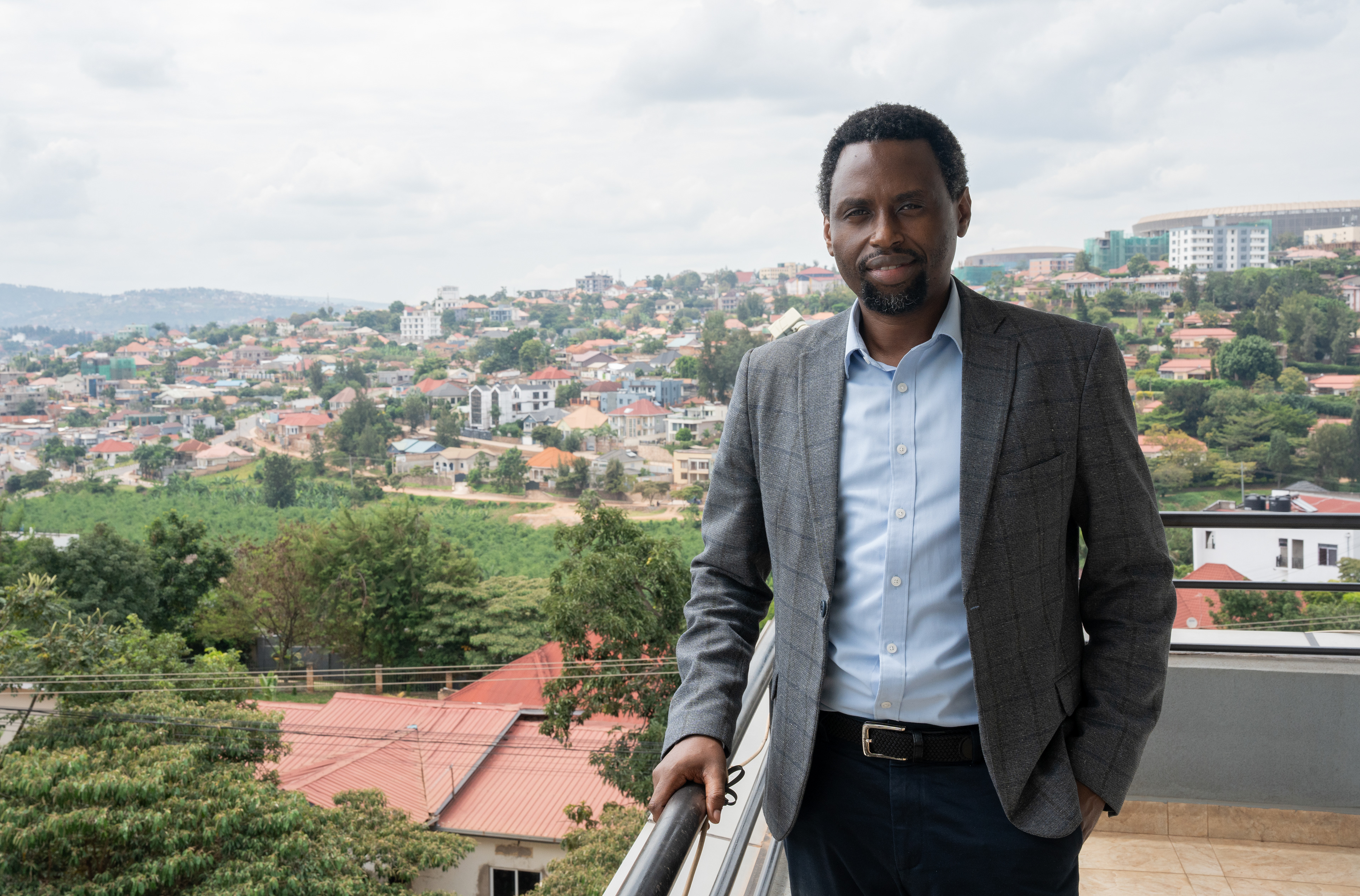 James Munyaneza, The New Times managing director and editor-in-chief, poses for a photo on the newsroom’s balcony overlooking the city on Tuesday, May 19, 2026 in Kigali, Rwanda.  The New Times is Rwanda’s leading daily news outlet established in 1995, a year after the genocide against the Tutsi. Media outlets, especially radio stations including Radio Télévision Libre des Mille Collines, spread hate propaganda that played a major role in inciting the genocide.   Journalism’s past in Rwanda informs how Munyaneza views its purpose today.   “Because of our past, we feel a burden to do journalism that unites, that inspires hope, that speaks to the aspirations of our people,” he said. (Evan Frilingos/ Evan Frilingos 2026)