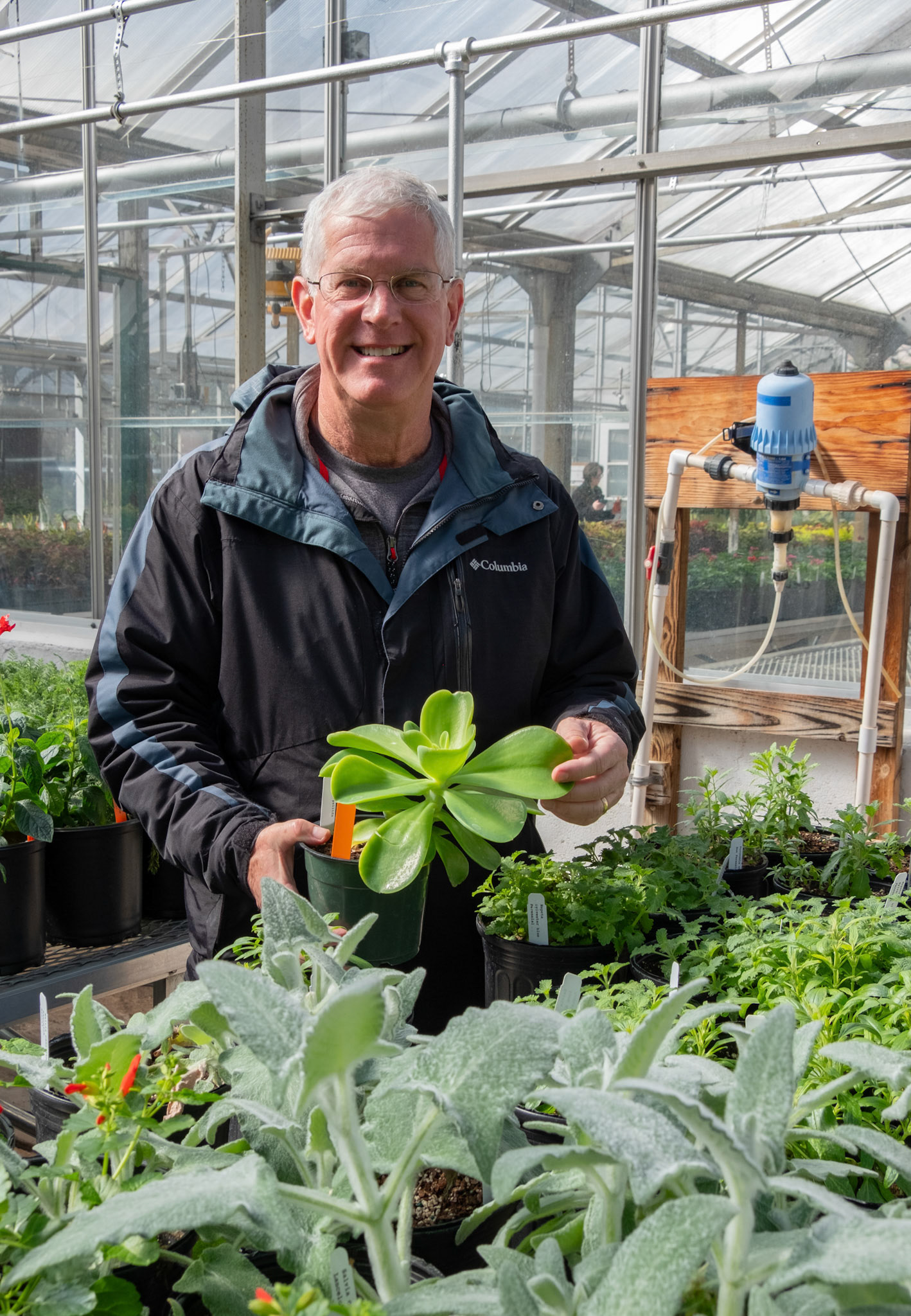 John Ruter, UGA proffessor of horticulture and the director of the Trial Garden, examines a plant at the UGA Trial Garden plant sale on Tuesday, Feb. 13, 2024. (Photo/Evan Frilingos; @frilingos.photos)