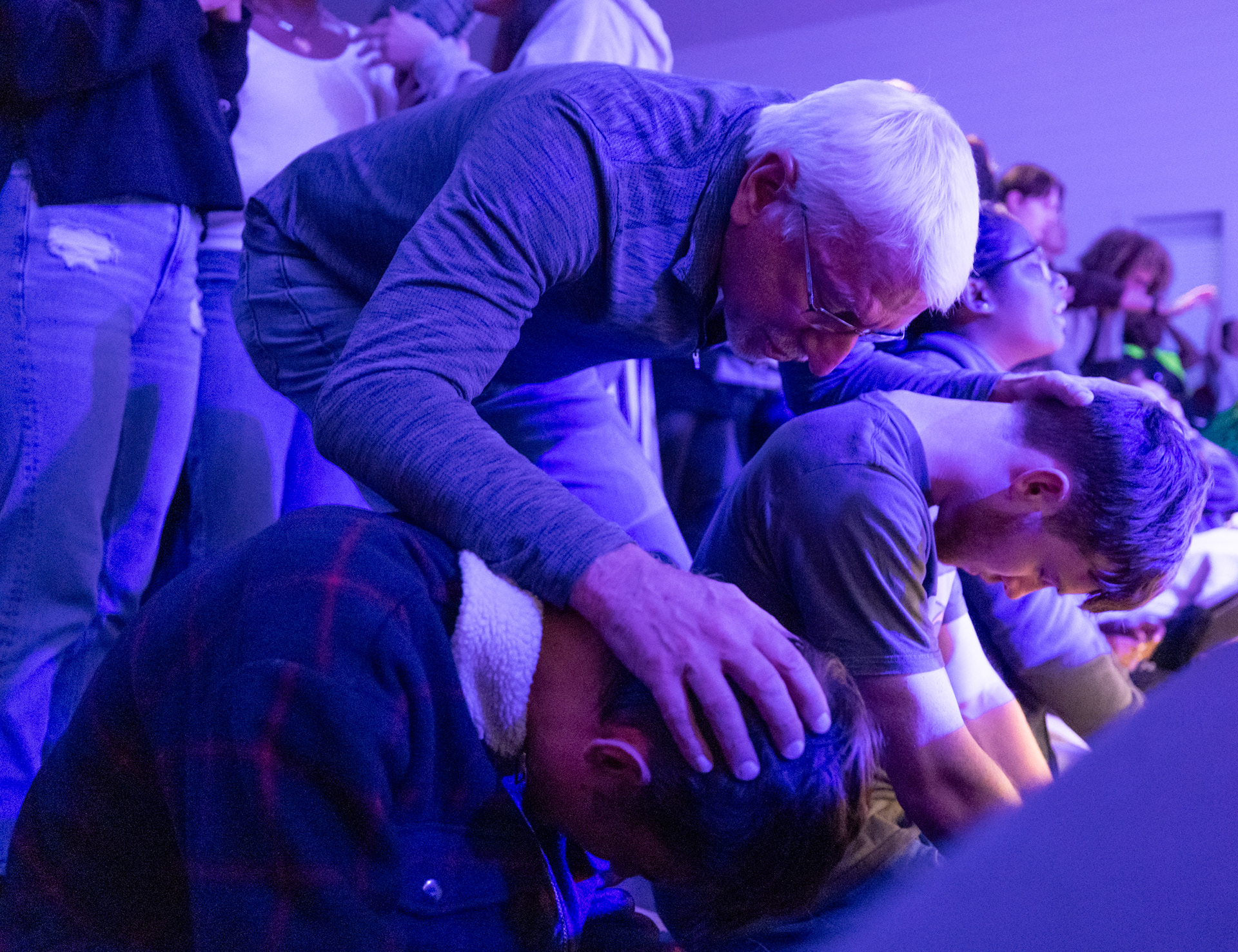 Bob Beckwith, Wesley director, prays for two students at Wesley Chapel in Athens, Georgia on Wednesday, Nov. 12, 2025. Wesley has seen an increase in male discipleship students in recent years, Beckwith said. (Photo/Evan Frilingos)