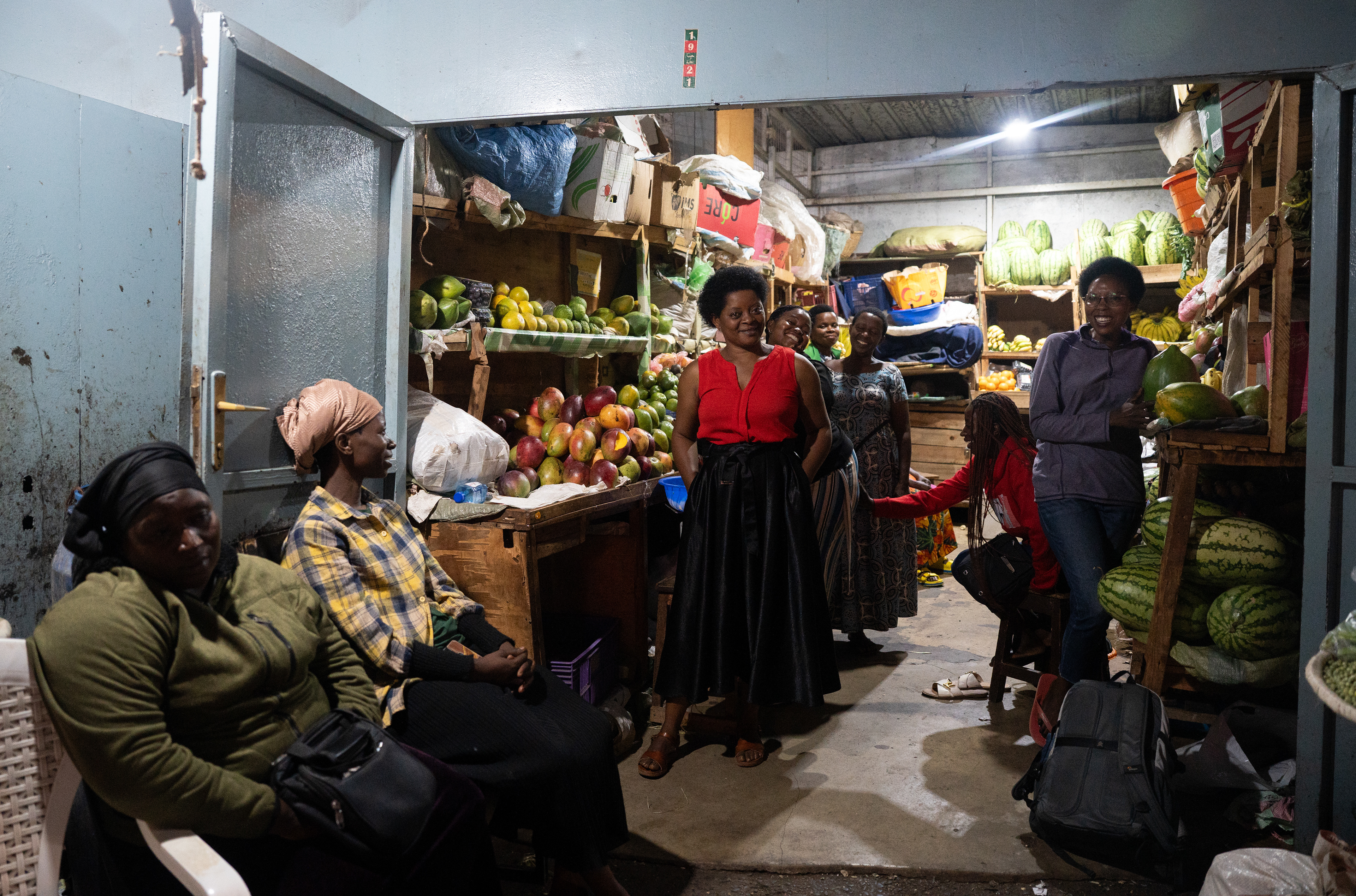 A group of women sell fruit at a fruit stand on Monday, May 25, 2026 in Kigali, Rwanda.  Read more at the story "Photojournalism and a fruit stand" on my website.  (Photo/Evan Frilingos 2026)