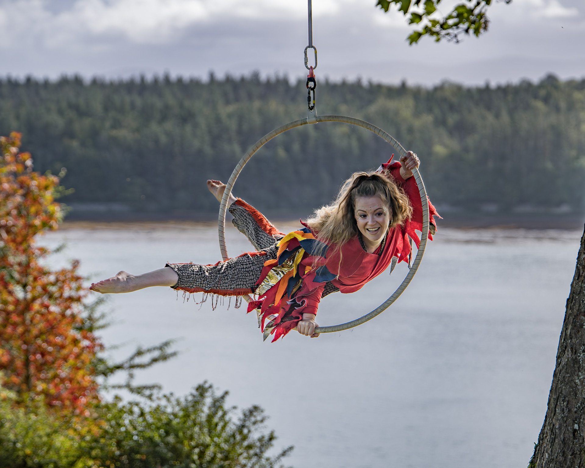 An aerialist performs in the trees of Plas Newydd