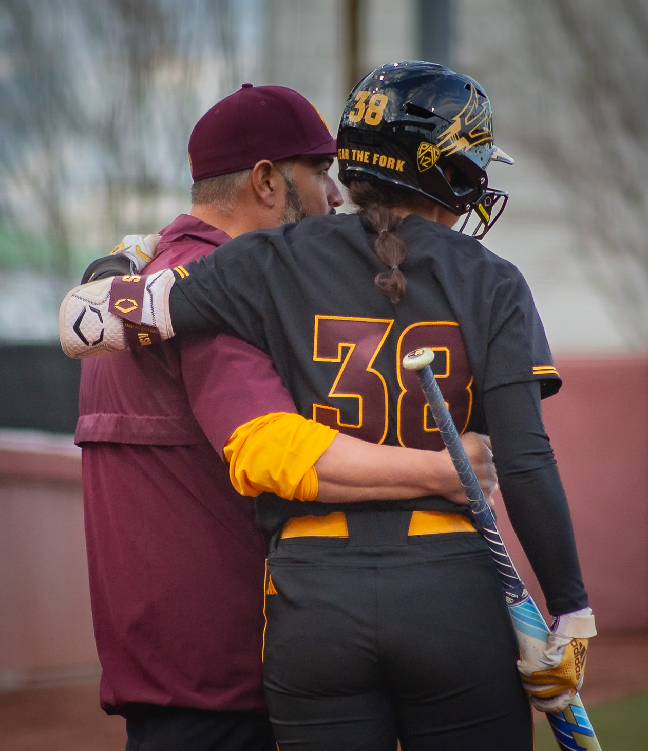 Kelsey Hall, Arizona State University outfielder, and assistant coach Jimmy Kolaitis talk before an at bat during a game at Alberta B. Farrington Softball Stadium in Tempe, Arizona. 