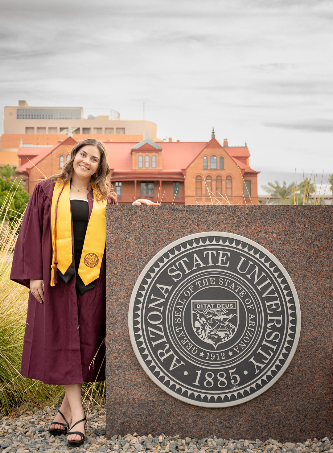Kaitlyn Wolfe, Arizona State University graduate, poses with the ASU sign in Tempe, Arizona. 