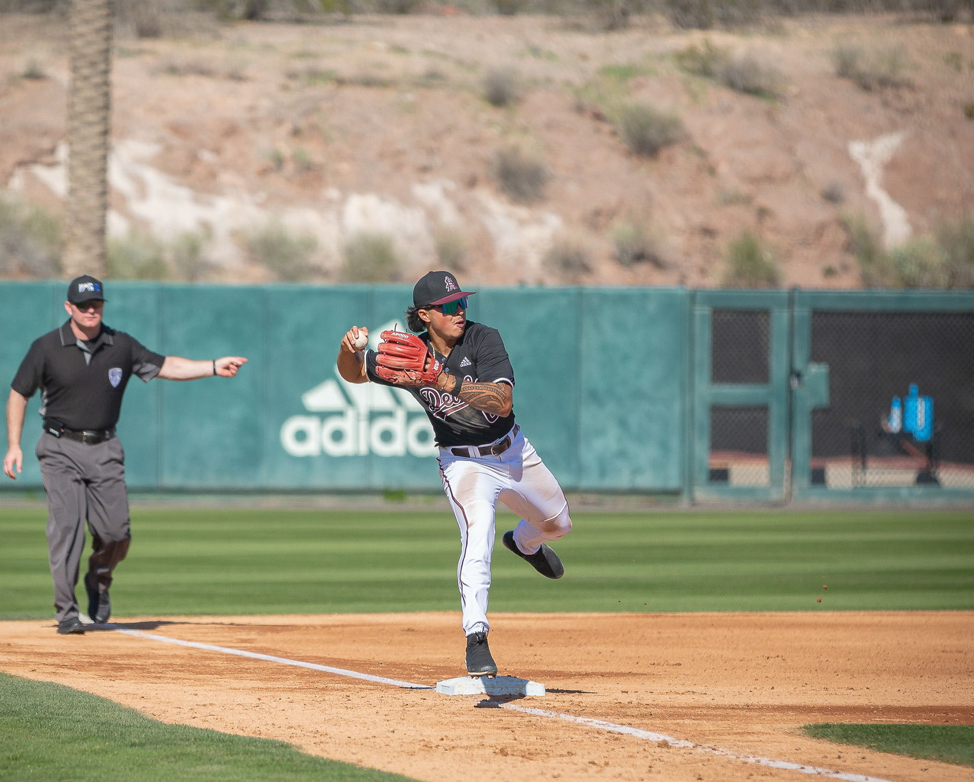 Nu’u Contrades, Arizona State University infielder, makes a throw to first base after fielding a ball to his right during a game at Phoenix Municipal Stadium on Saturday, February 17, 2024 in Phoenix, Arizona. 