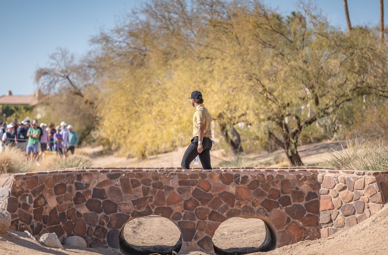 Josele Ballester, ASU golfer and PGA amateur, crosses the bridge to the fairway after teeing off on the third hole at TPC Scottsdale on Thursday, February 6, 2025 in Scottsdale, Arizona. 