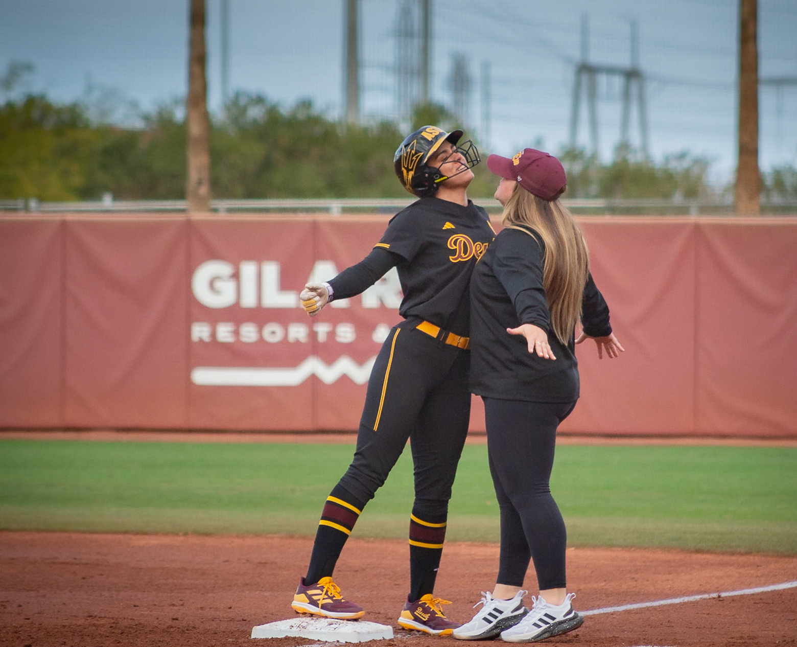  Kelsey Hall, Arizona State University outfielder, and assistant coach Hailey Decker chest bump after a hit during a game at Alberta B. Farrington Stadium in Tempe, Arizona. 