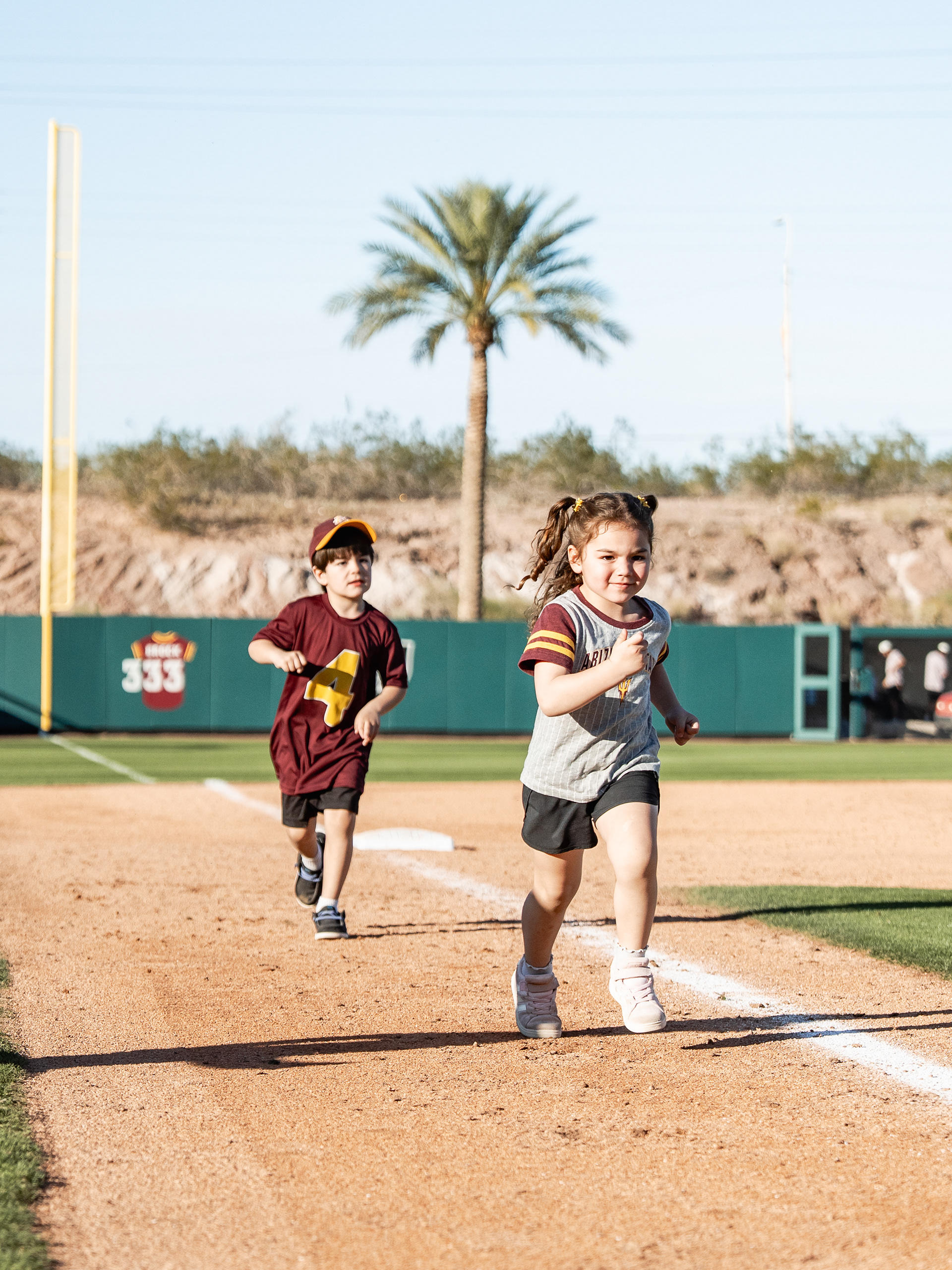 Young Arizona State University baseball fans run the bases after a home game against St. John’s University at Phoenix Municipal Stadium on Sunday, February 22, 2026 in Phoenix, Arizona. 