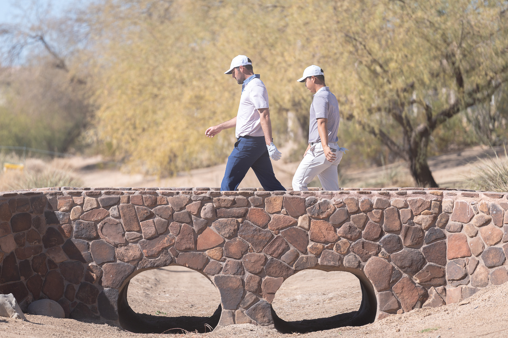  Scottie Scheffler and Tom Kim cross the bridge to the fairway after teeing off on the third hole at TPC Scottsdale on Thursday, February 6, 2025 in Scottsdale, Arizona. 