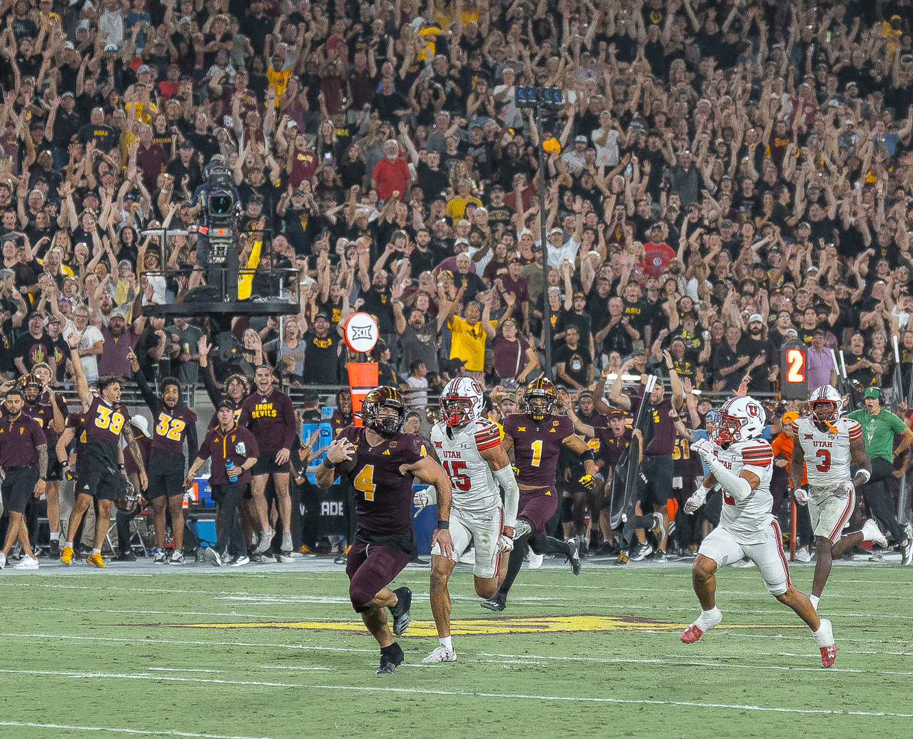 Cam Skattebo, Arizona State University running back, runs for a touchdown while being chased by two Utah defenders at Mountain America Stadium on Friday, October 11, 2024 in Tempe, Arizona. 