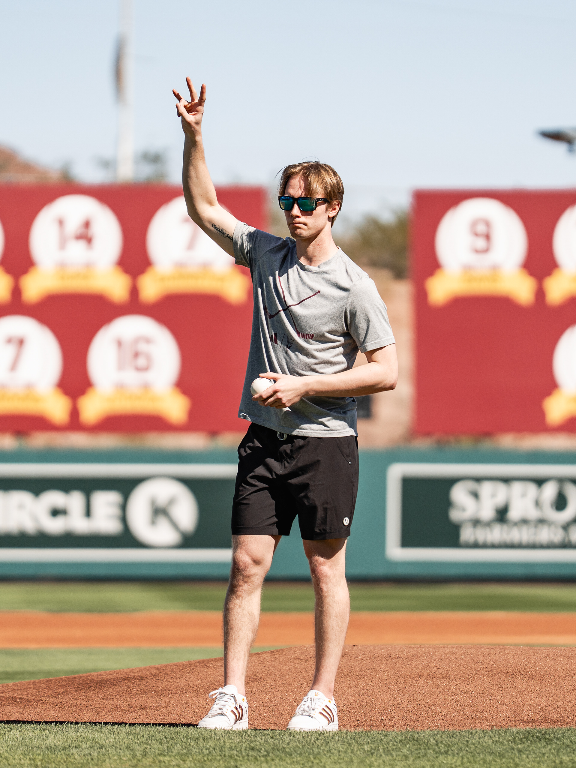 Kyle Smolen, Arizona State University Hockey forward, does the forks up sign before throwing out the first pitch before a home game against St. John’s University at Phoenix Municipal Stadium on Sunday, February 22, 2026 in Phoenix, Arizona. 