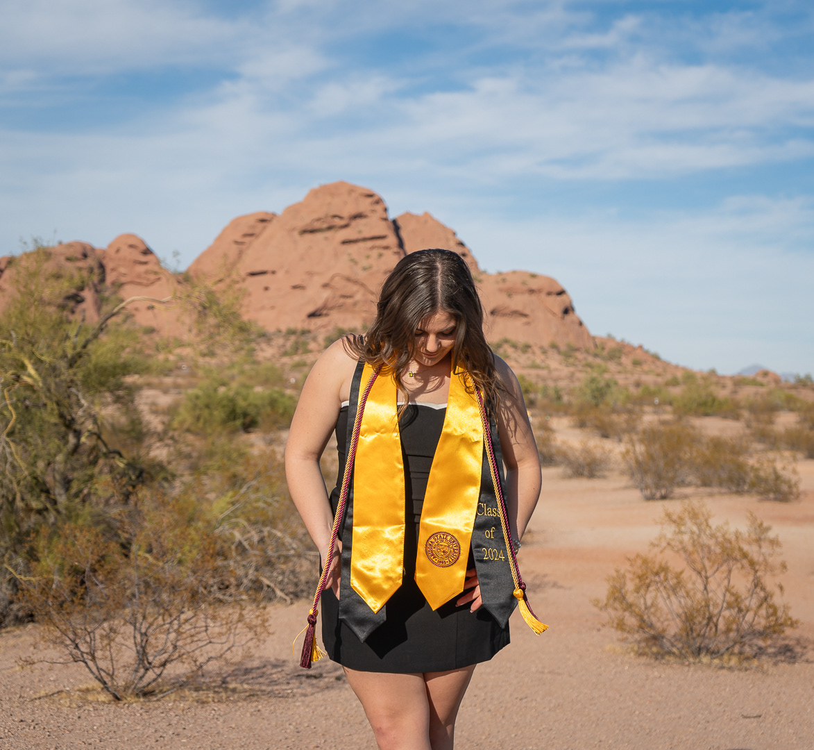 Kaitlyn Wolfe, Arizona State University graduate, poses with her stoles and cords at Papago Park in Phoenix, Arizona.