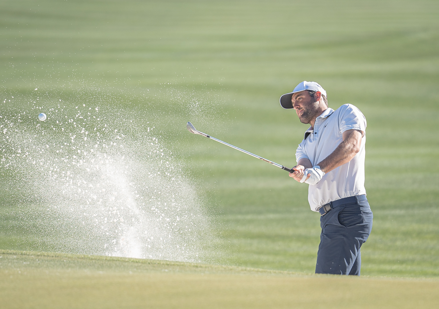 Scottie Scheffler hits a shot from a bunker during practice rounds at TPC Scottsdale on Tuesday, February 4, 2025 in Scottsdale, Arizona. 