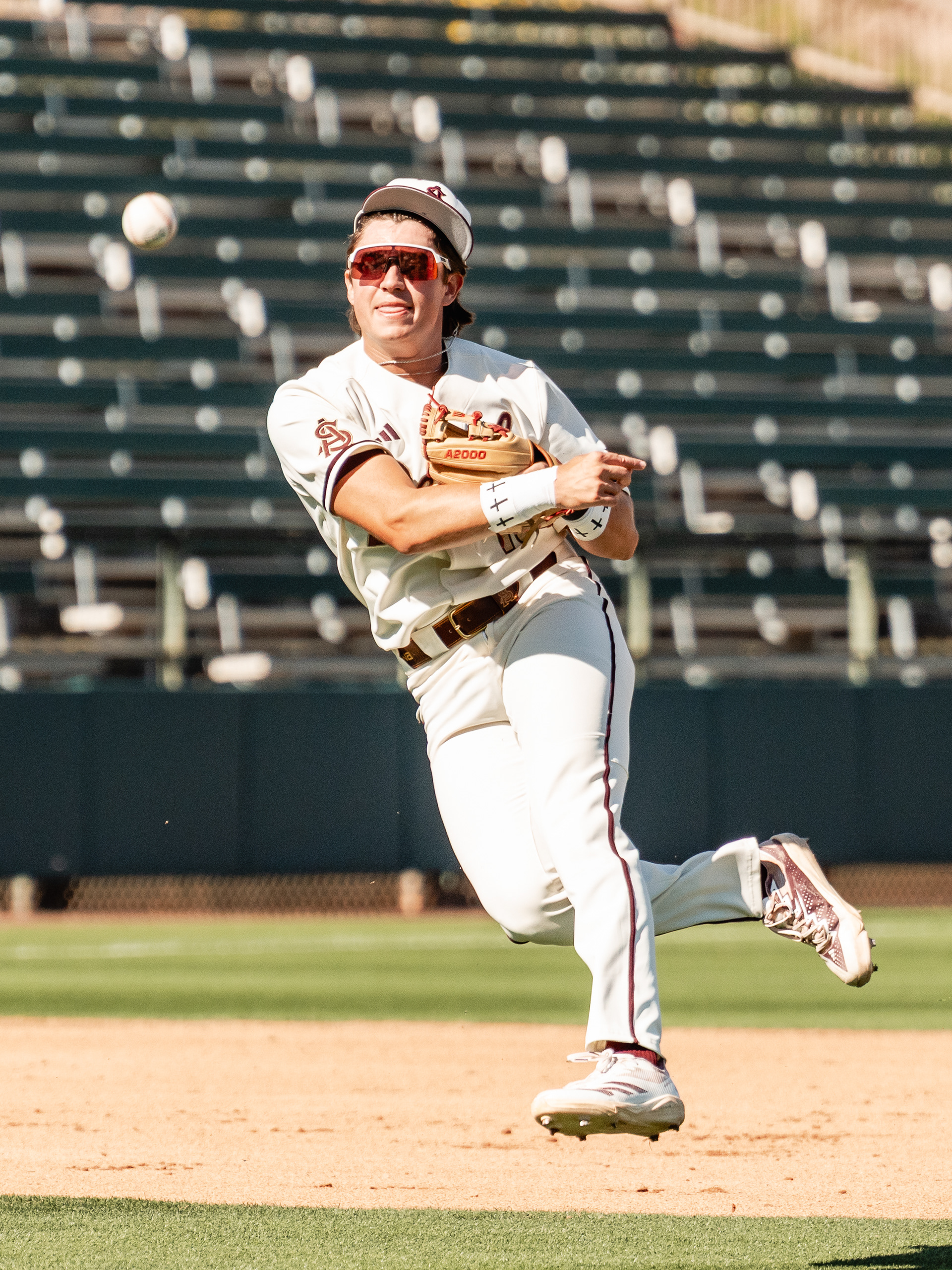 PJ Moutzouridis, Arizona State University infielder, makes a throw to first base during a home game against St. John’s University at Phoenix Municipal Stadium on Sunday, February 22, 2026 in Phoenix, Arizona. 