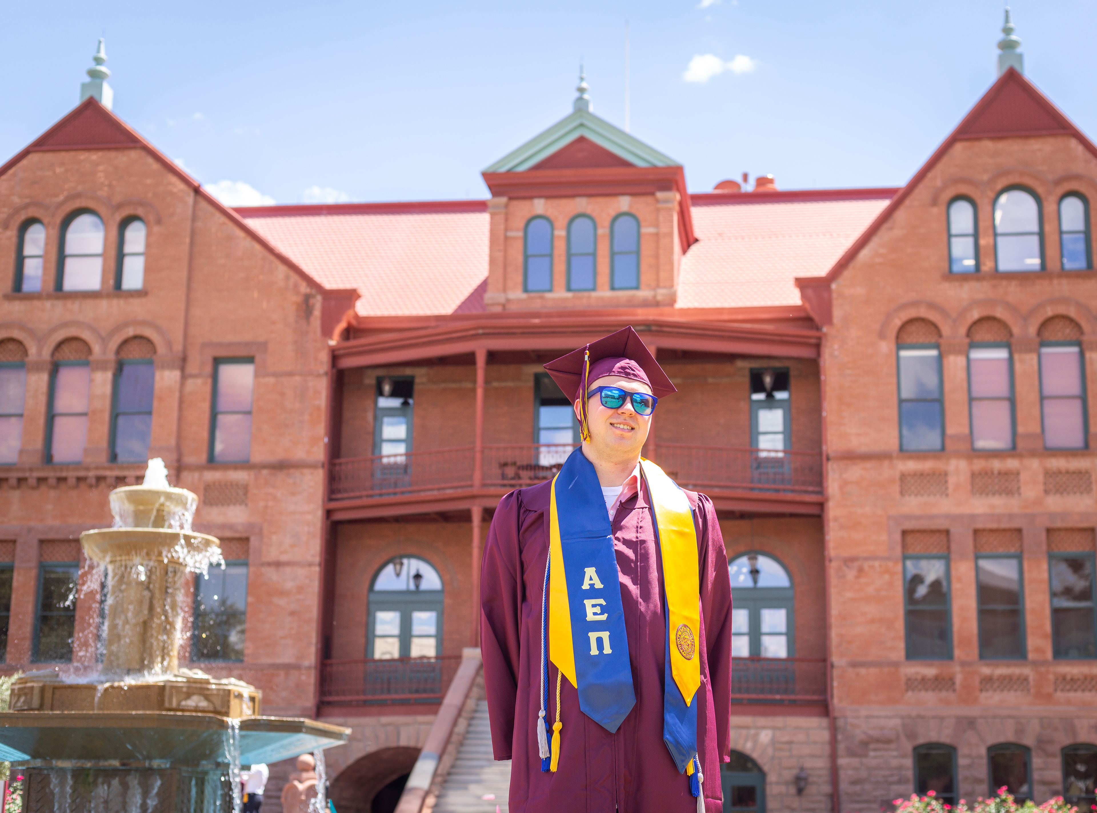 Tyler Baum, Arizona State University graduate, poses outside of Old Main in Tempe, Arizona. 